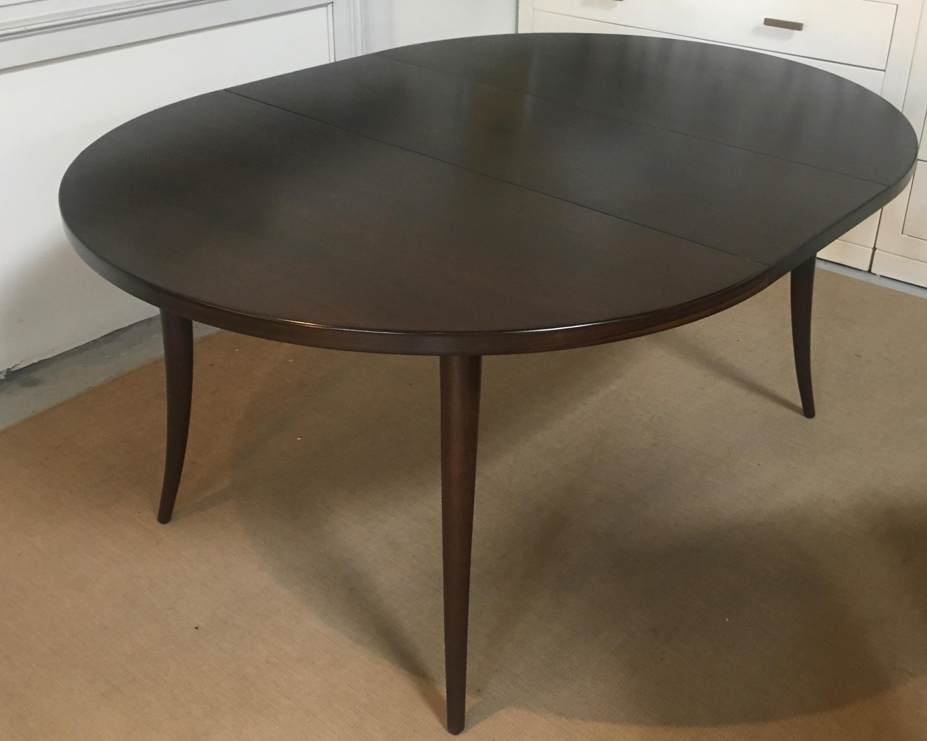 Newly refinished Harvey Probber dining table with elegant saber formed legs. A subtle banded profile, draws one attention to the beautiful rich wood grain on table's top. The whole table is fully refinished with new custom chocolate brown stain and