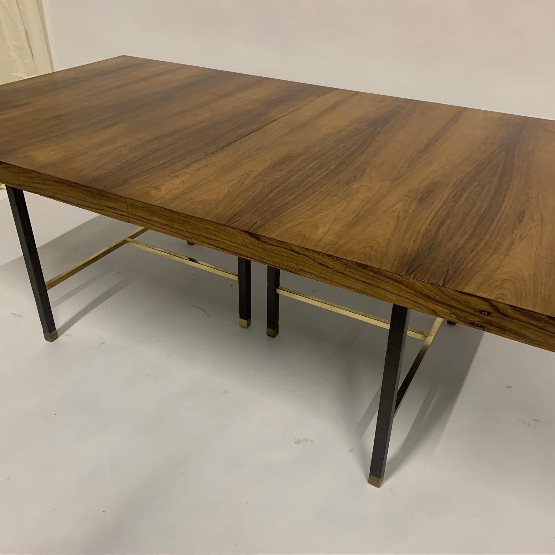 Stunning all original Harvey Probber dining table in Brazilian rosewood with brass stretchers and feet, and mahogany base/ legs. Comes with 2 additional leaves. Each leaf is 16