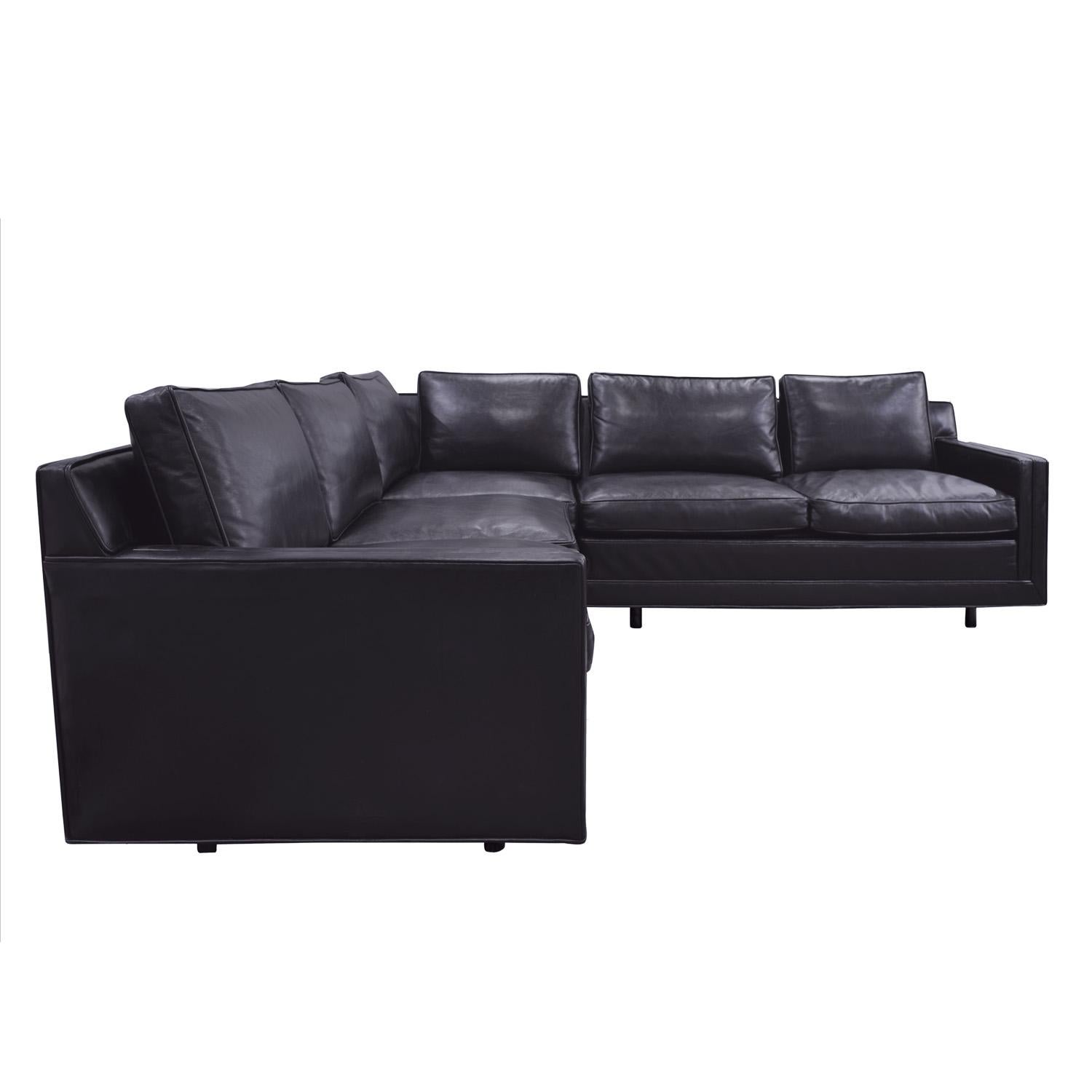 Clean line sectional (2 piece) sofa upholstered in Edelman black leather with mahogany legs by Harvey Probber, American 1950's (signed with original label “furniture design by HARVEY PROBBER”). This sofa was recently reupholstered in black leather