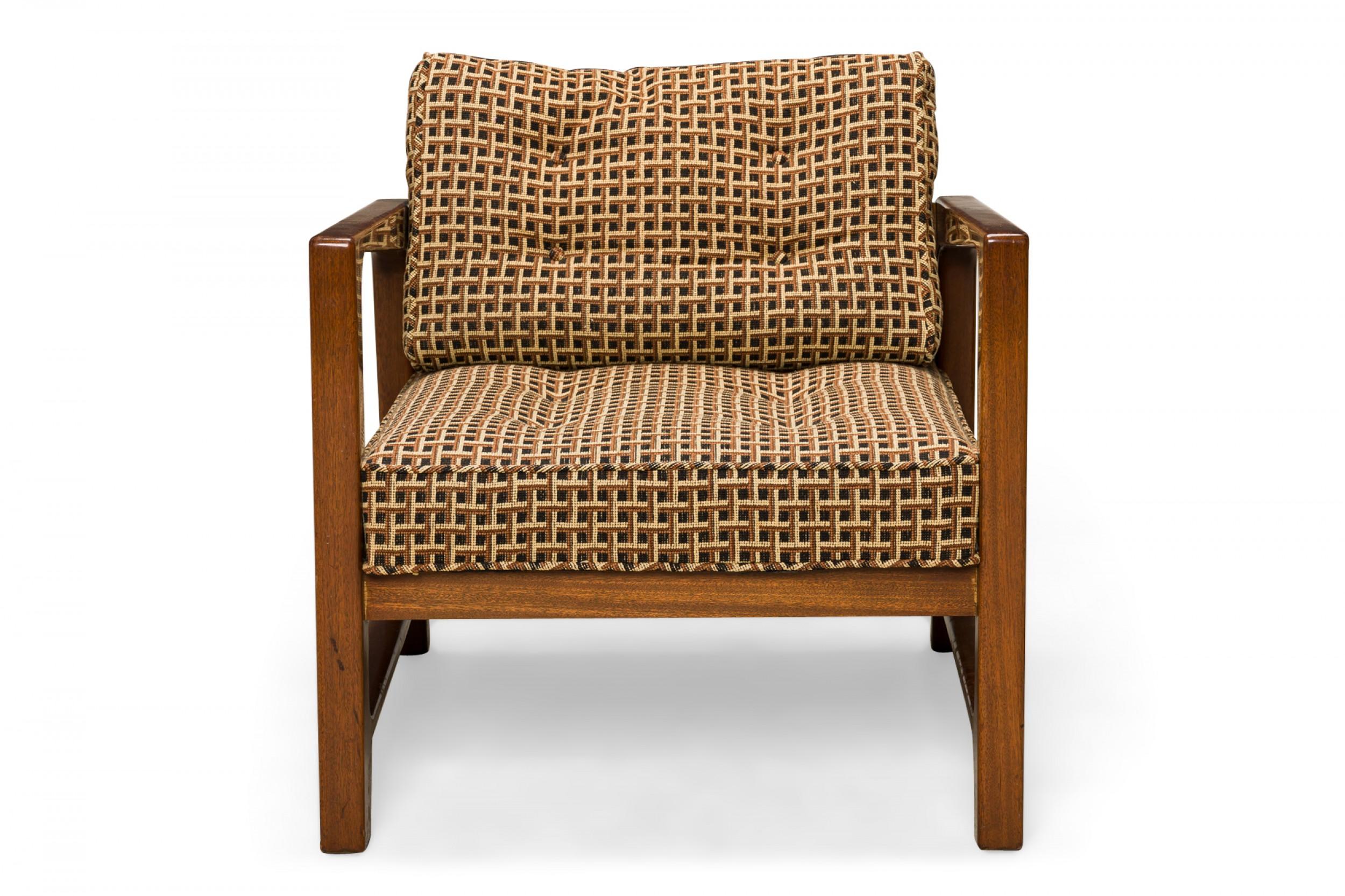 American mid-century lounge armchair with a shaped walnut frame with two wooden armrests, and seat and back cushions upholstered in a geometric patterned fabric in neutral browns and beiges with button tufting. (HARVEY PROBBER)