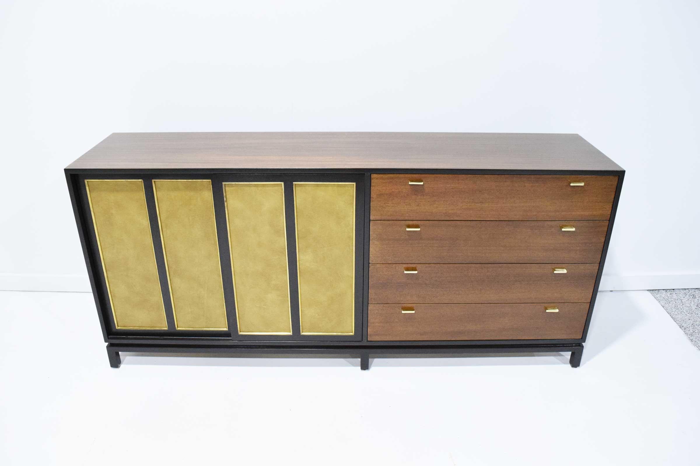 Fully restored. Harvey Probber sideboard with two front sliding doors in a gold leaf finish. Interior has four sets of drawers on each side. Right side of sideboard has four sets of drawers with gold hardware.
  