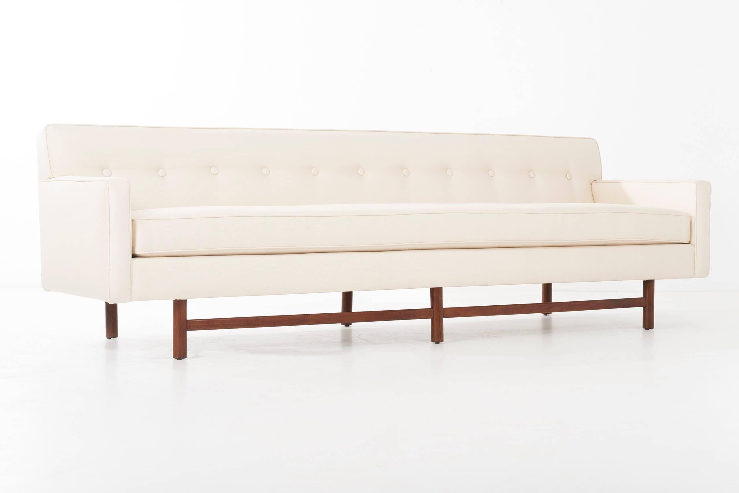 Probber for Harvey Probber Inc. Tuxedo sofa, features seven tufted button back with lumbar support across the length. Single deck cushion, rebuilt and restored, new foam with Great Plains cotton/poly blend fabric.
Solid walnut legs with front