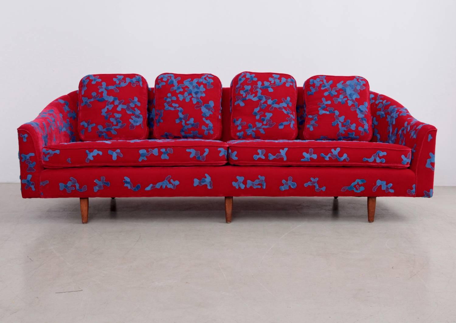 Hard to believe, that this art piece is completely hand embroidered by master artisans in India.
The superb color combination of sky blue cotton thread on the deep red silk velvet base fabric give this eye-catching vintage Harvey Probber sofa dated