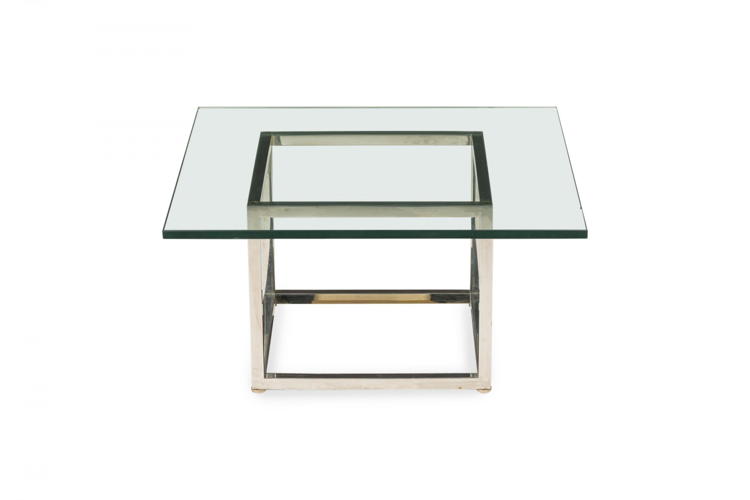 American Mid-Century square coffee / cocktail table with a thick square clear glass top resting on an open cube-form chrome plated steel base. (HARVEY PROBBER).
 