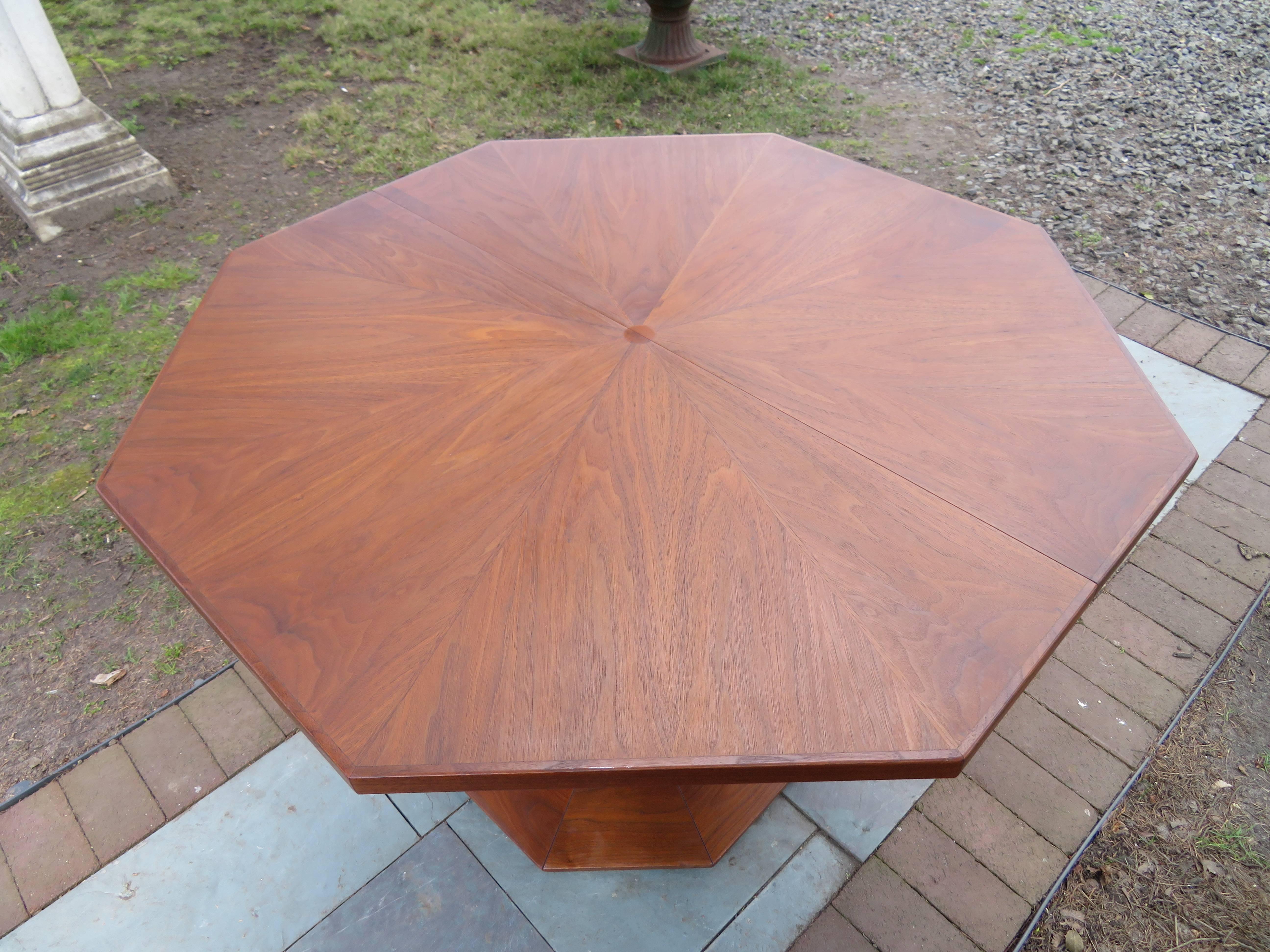 Gorgeous Mid-Century Modern cathedral style Probber inspired pedestal dining table with two leaves. The top is amazing with circle inlays and dynamite octagon shape, the two leaves are well matched to the original finish. The sculptured walnut table