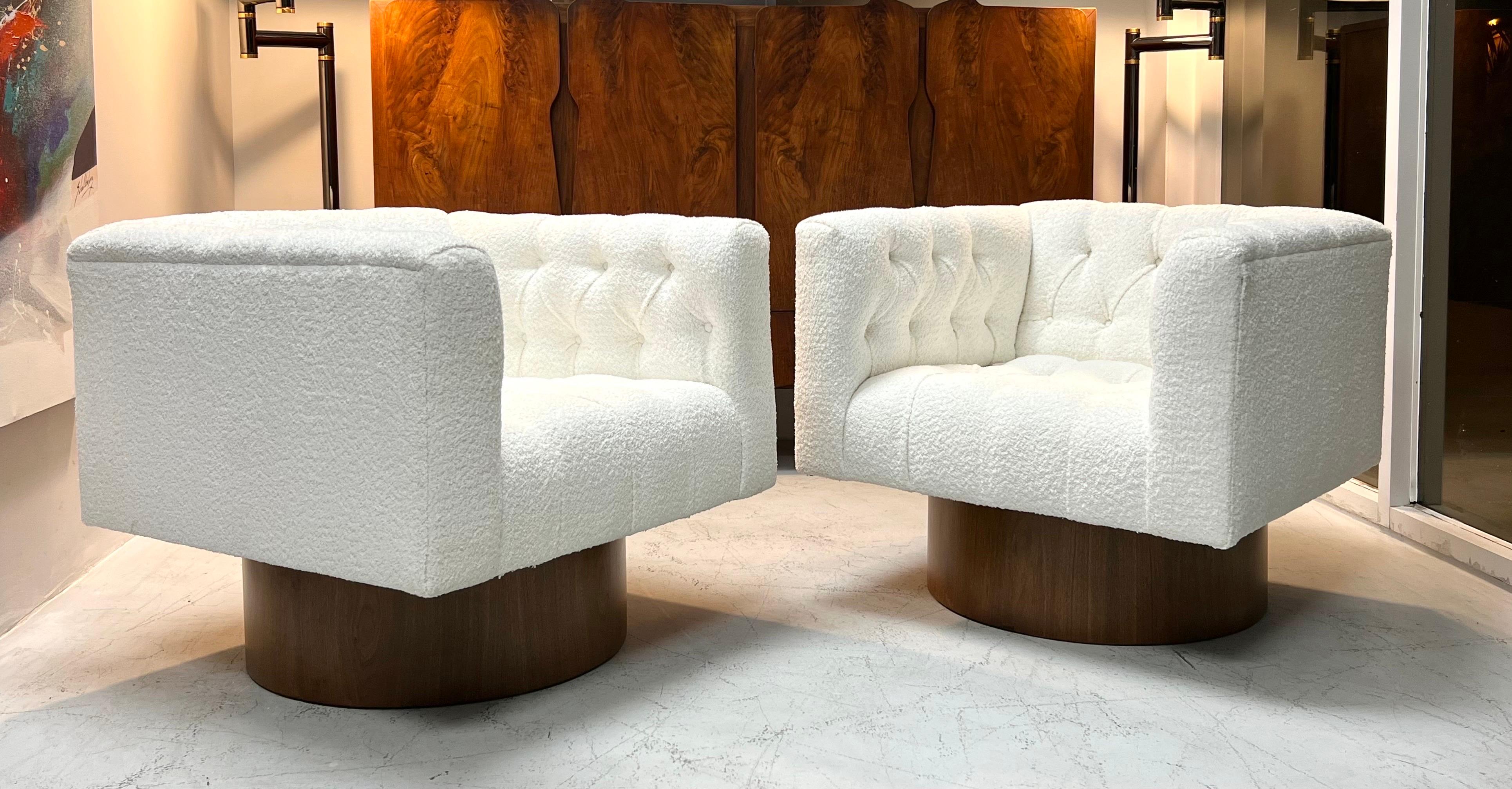 A pair of classic swivel chairs by Harvey Probber. The bases are walnut. And the upholstery is a soft boucle. The swivel is 360.