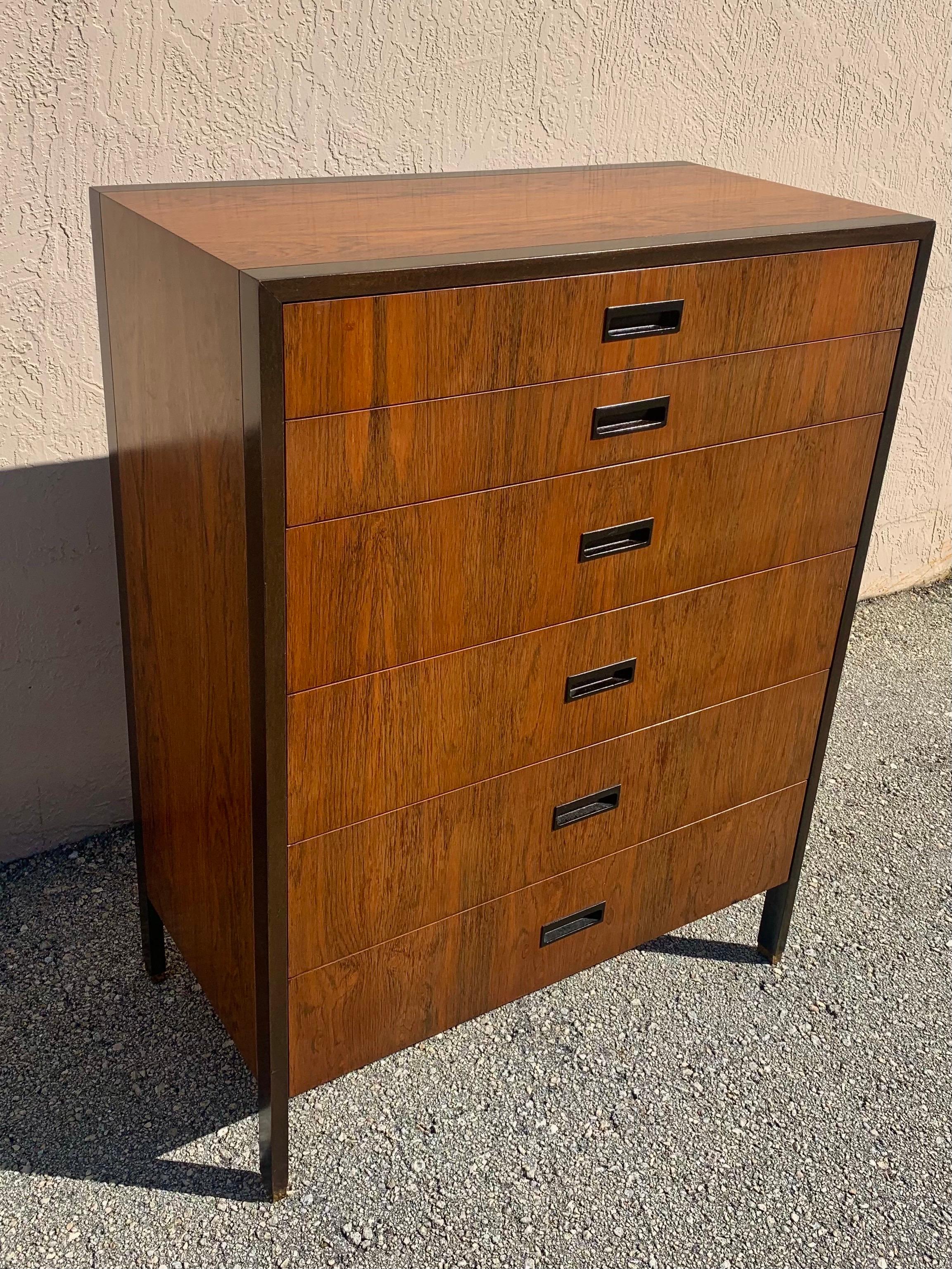 Exceptional Harvey Probber dresser in rosewood and ebonized mahogany trim and brass capped feet. Wood carved drawer pulls are embedded into the front of the drawers. Ample drawer space. Original finish is in good condition with light patina. Harvey