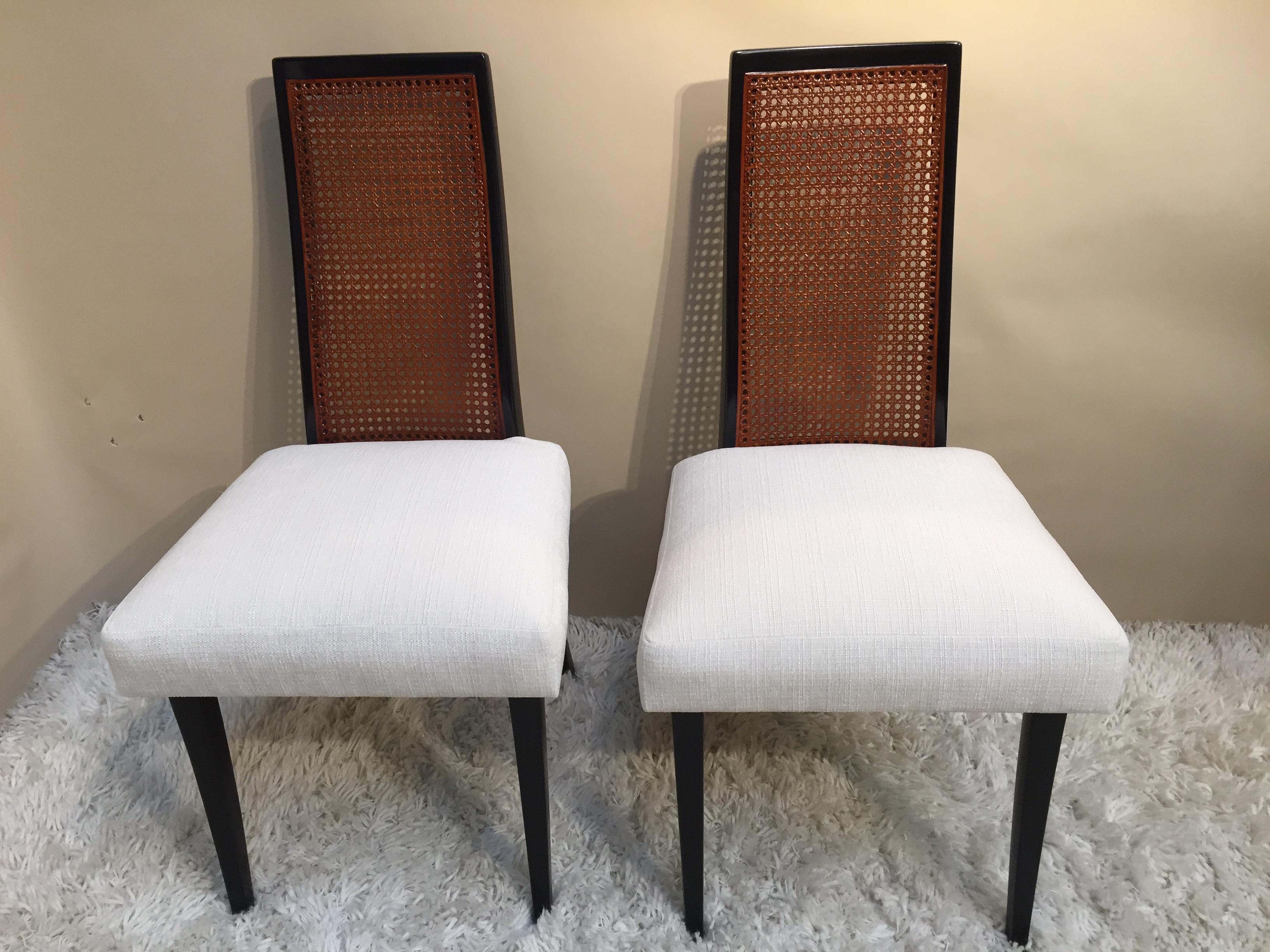 Harvey Probber tall high cane back chairs, dark walnut finish off white chenille fabric, saber leg design. Probber was born in Brooklyn, New York in 1922. While attending high school, he took a part-time job in a used-furniture store, and was
