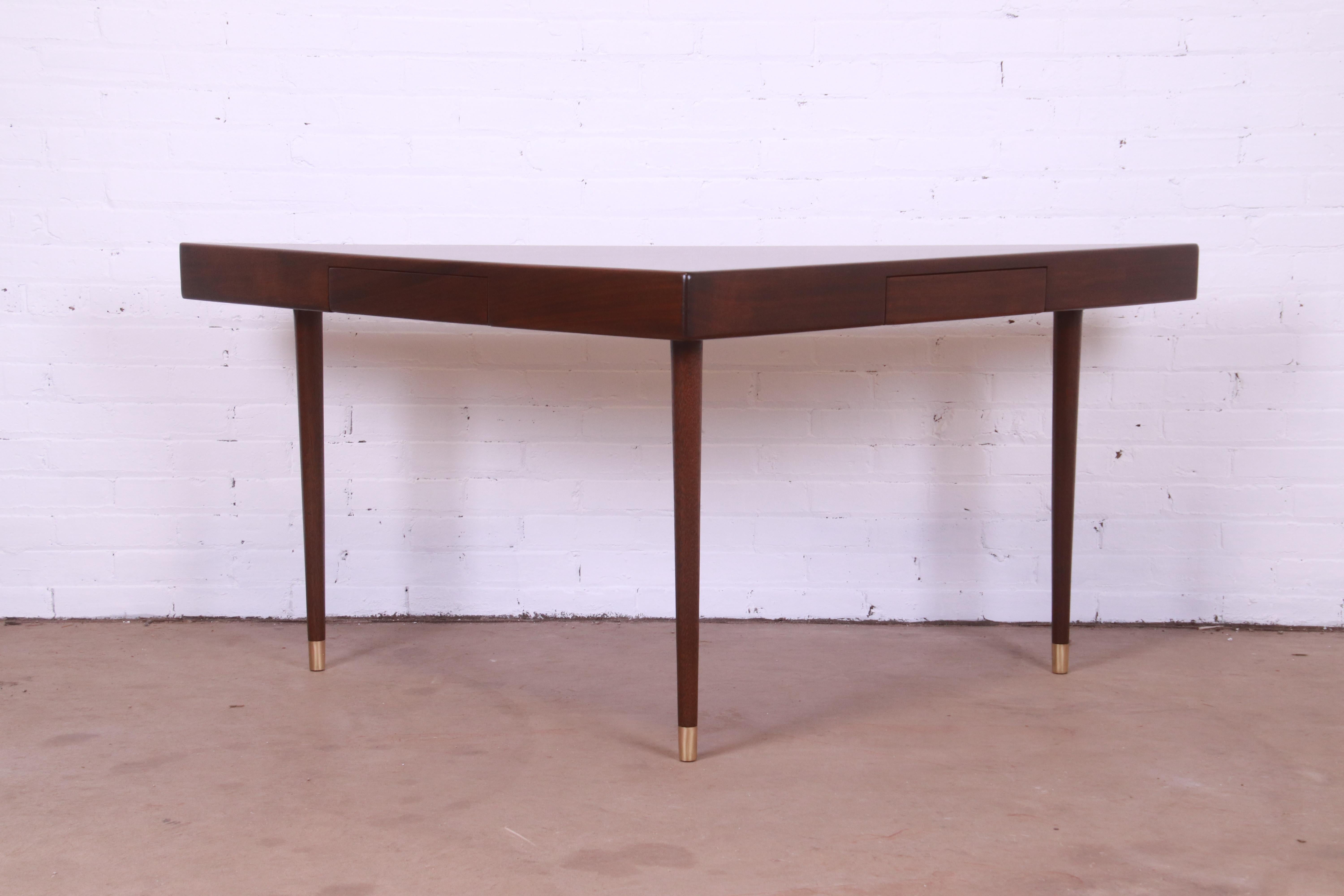 A unique and gorgeous mid-century modern triangle desk, console, or sofa table

By Harvey Probber

USA, 1950s

Teak wood, with brass-capped feet.

Measures: 67