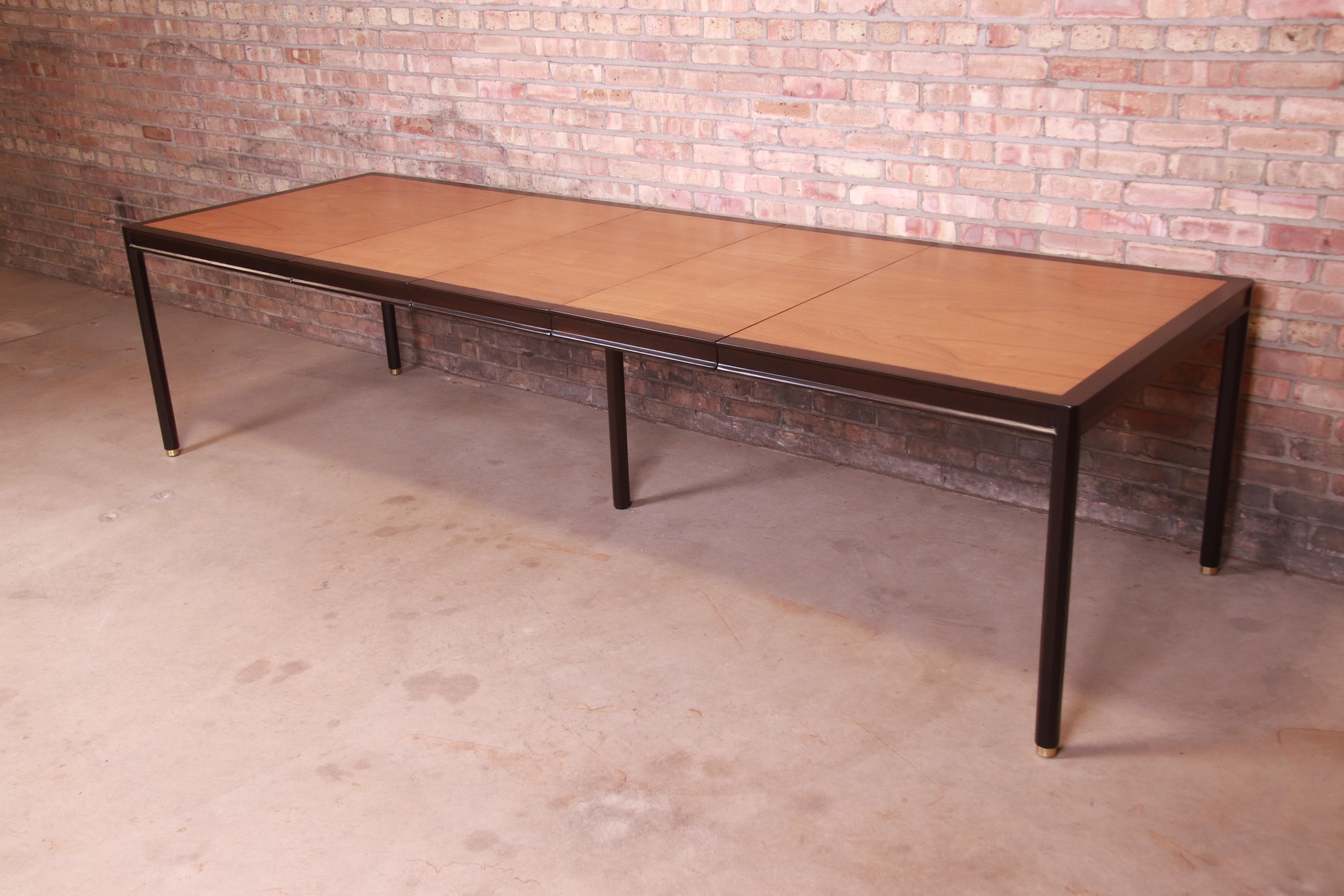 A gorgeous Mid-Century Modern extension dining table

By Harvey Probber

USA, 1960s

Book-matched teak top, with ebonized mahogany trim and legs and brass-capped feet.

Measures: 60.25