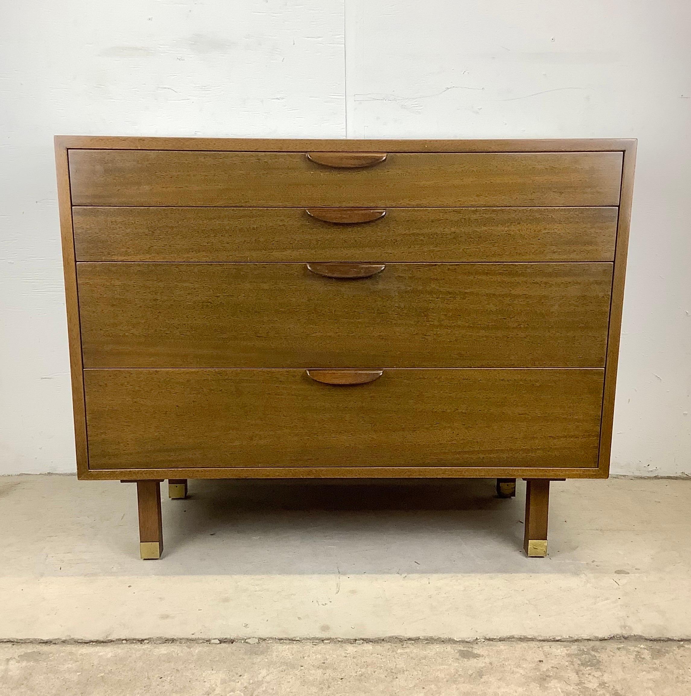This striking Mid-Century Modern dresser and desk set from designer Harvey Probber features quality 1950s design in a vintage Mahogany finish. The carved wood handles and brass sabot feet add to the mid-century appeal of the matching modular corner