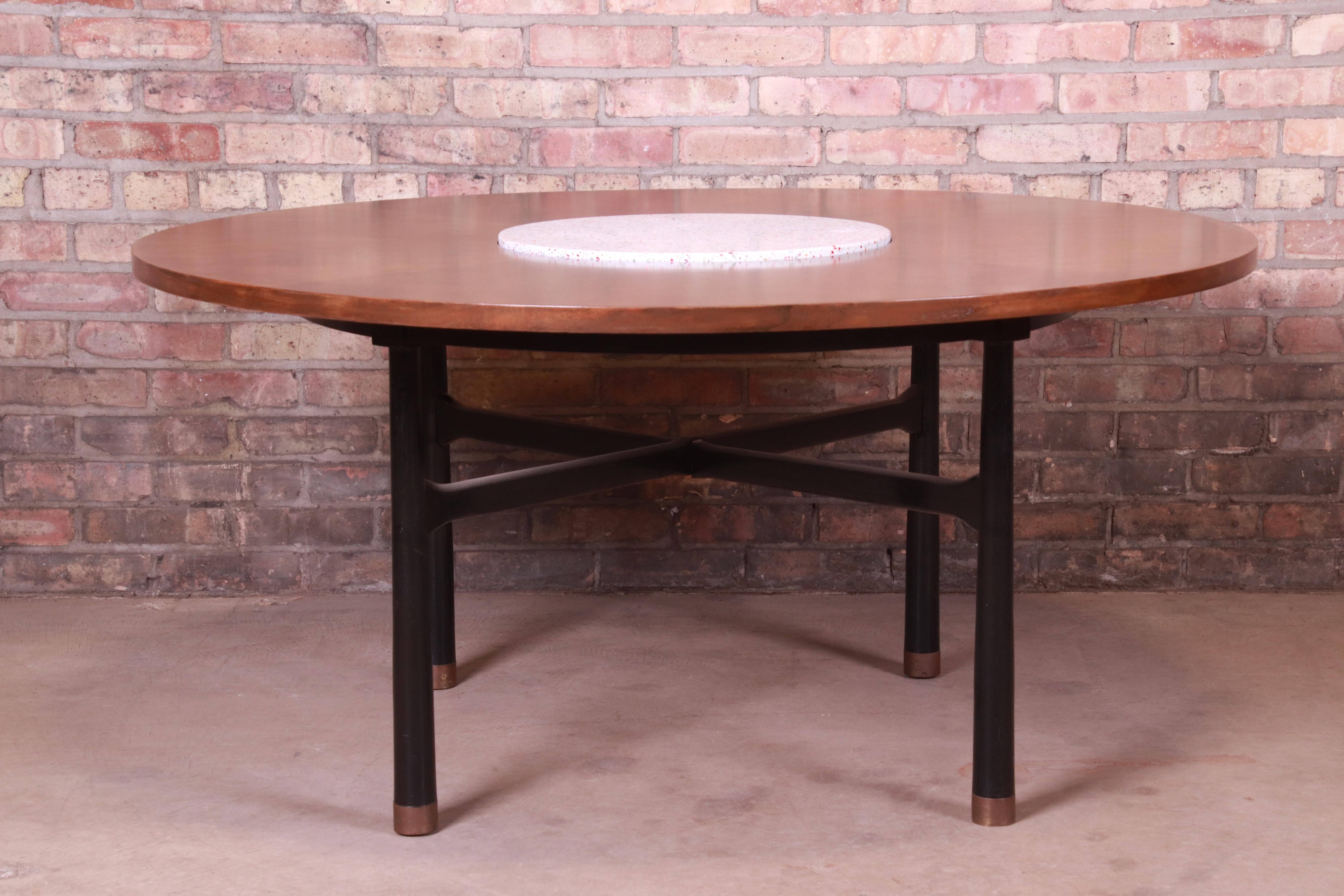 An exceptional Mid-Century Modern center table or game table

By Harvey Probber

USA, 1950s

Walnut top with terrazzo insert, ebonized walnut legs, and brass-capped feet.

Measures: 50