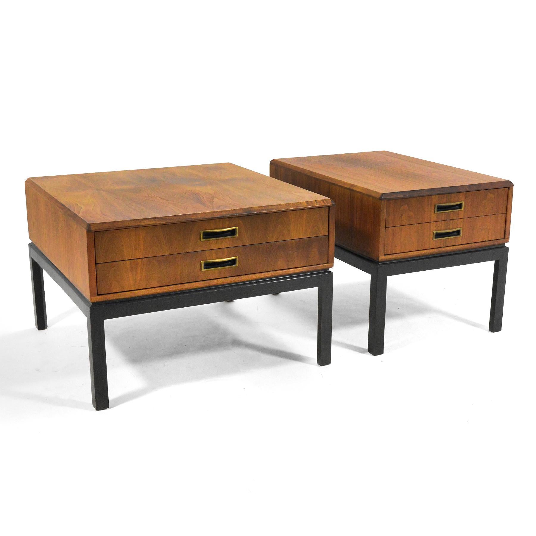 This handsome pair of side tables or nightstands by Harvey Probber features walnut cases with two drawers and attractive beveled edge details supported by black bases/ legs.

Measures: Larger table: 21