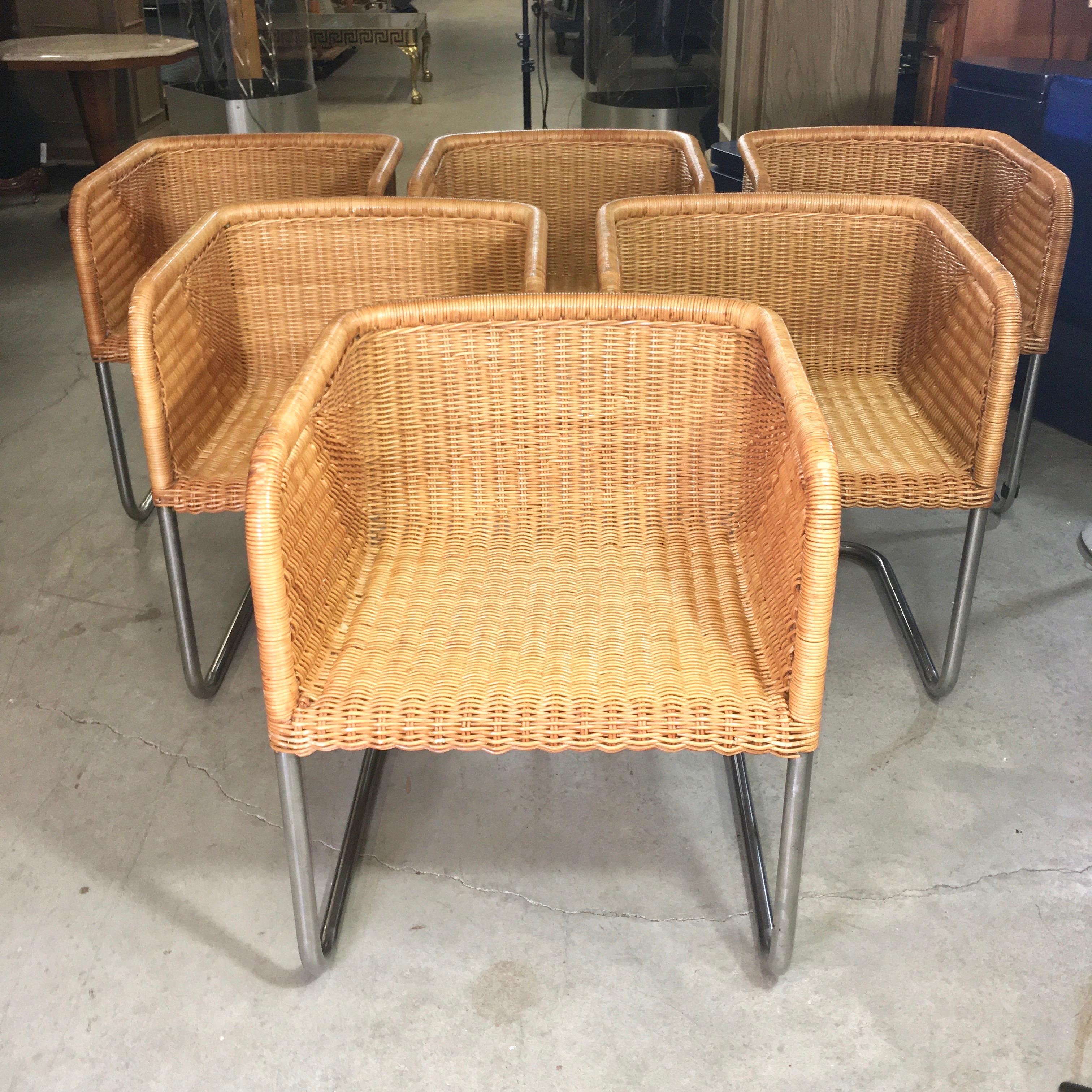 Hard to find a set of six of these comfortable and chic woven rattan and chromed tubular steel chairs from Harvey Probber. These are all in very good condition with no broken fibers and only slight wear to the varnish on top of the arms. They also