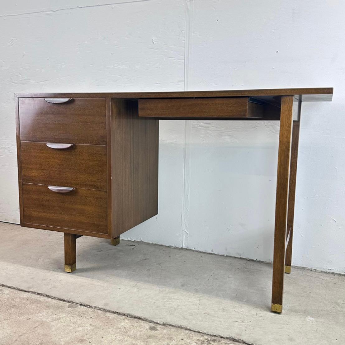 This impressive mid-century modern writing desk from Harvey Probber features a striking yet simple 1950's design in quality manufacture. The vintage mahogany finish, carved wood handles, and brass sabot feet all showcase the unique design of this