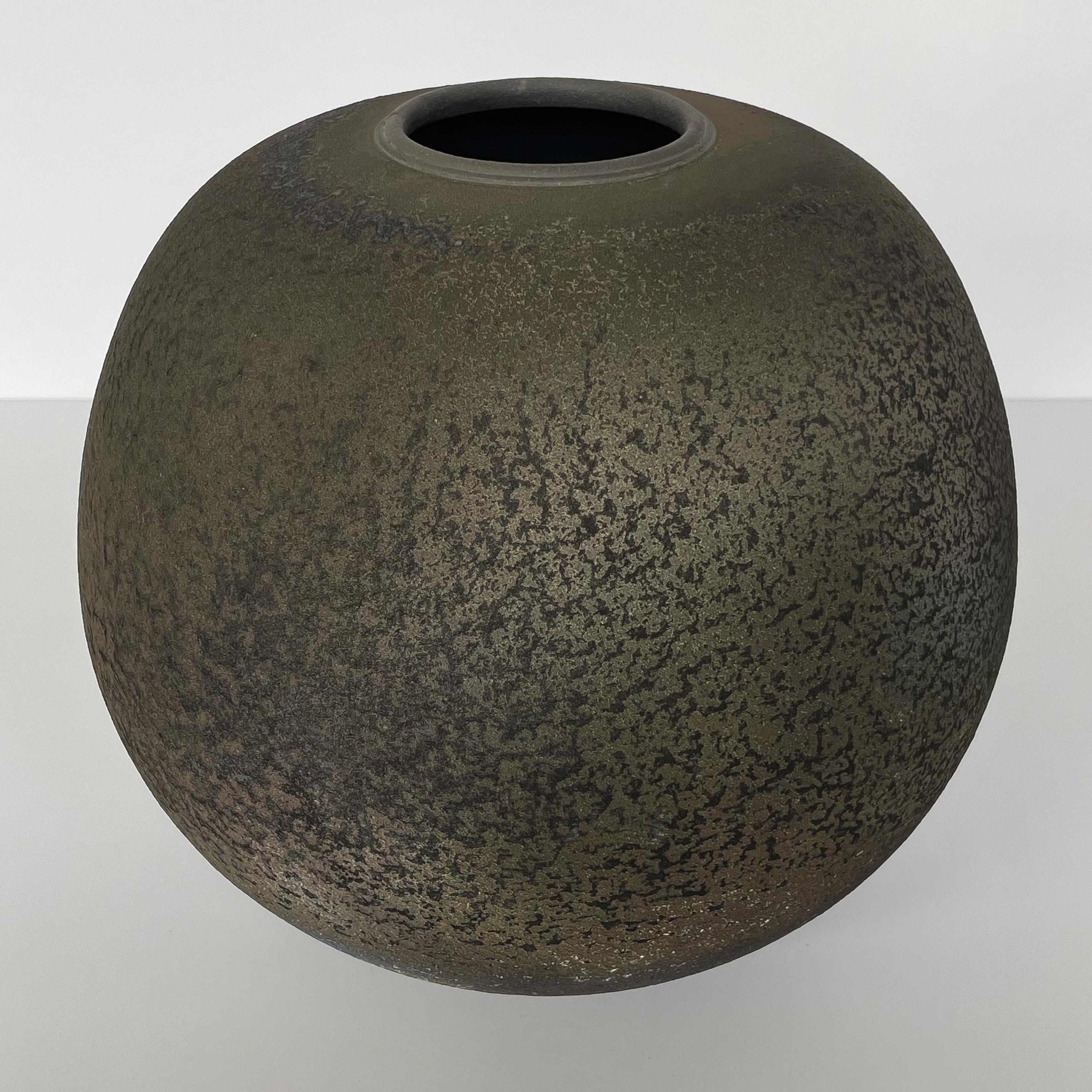 Raku fired stoneware vessel by Harvey Sadow (American, b. 1946), circa 1984. This hand thrown ceramic vase features a textural glaze in bronze, gray, rust and earthtones. Inscribed H. Sadow, Maryland 1984. Measures: 11