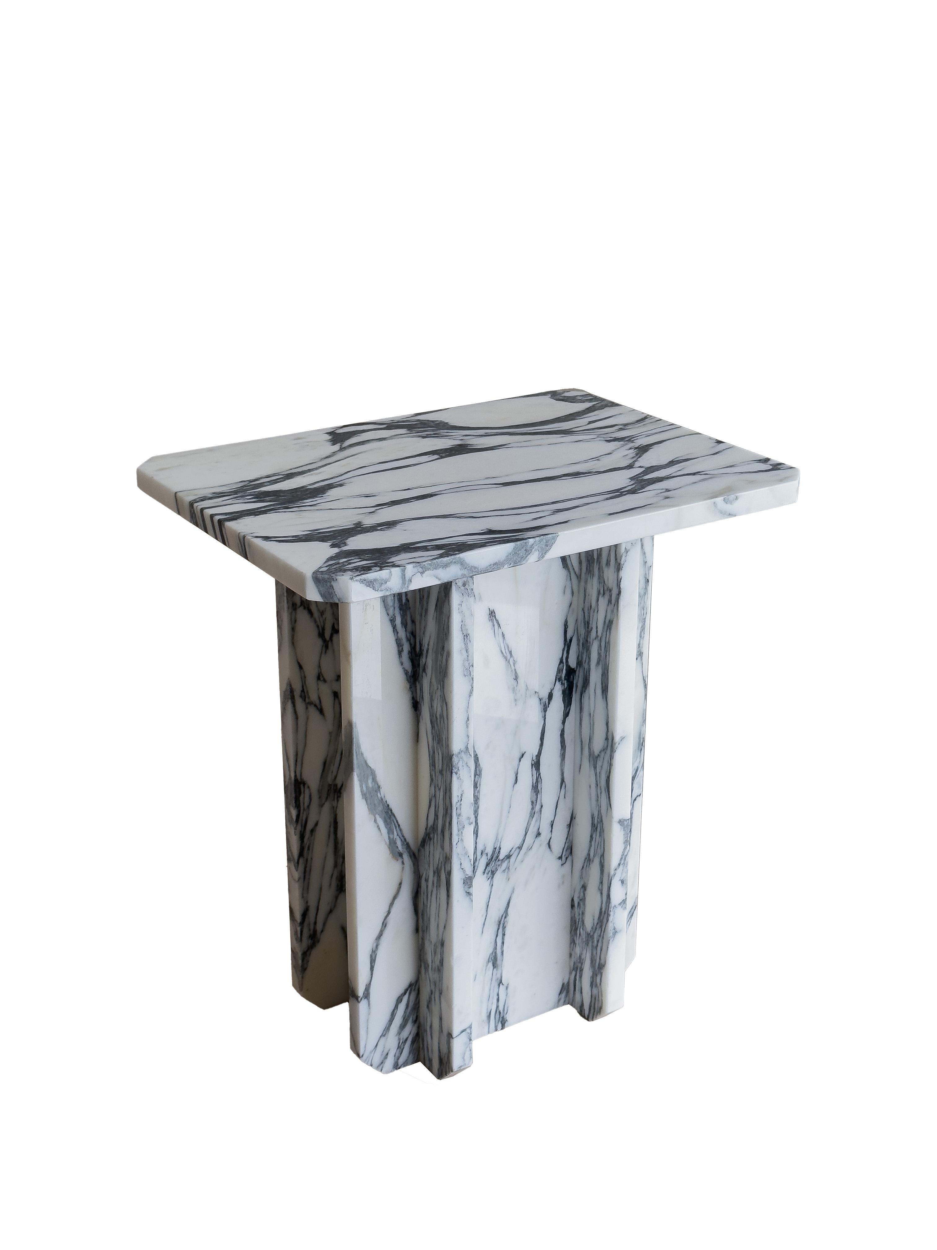 This contemporary side table is crafted from Italian marble, giving it a unique and luxurious look. The arabescato marble features high contrast natural veins, adding to its intricate beauty. Its well crafted design features unique chamfered