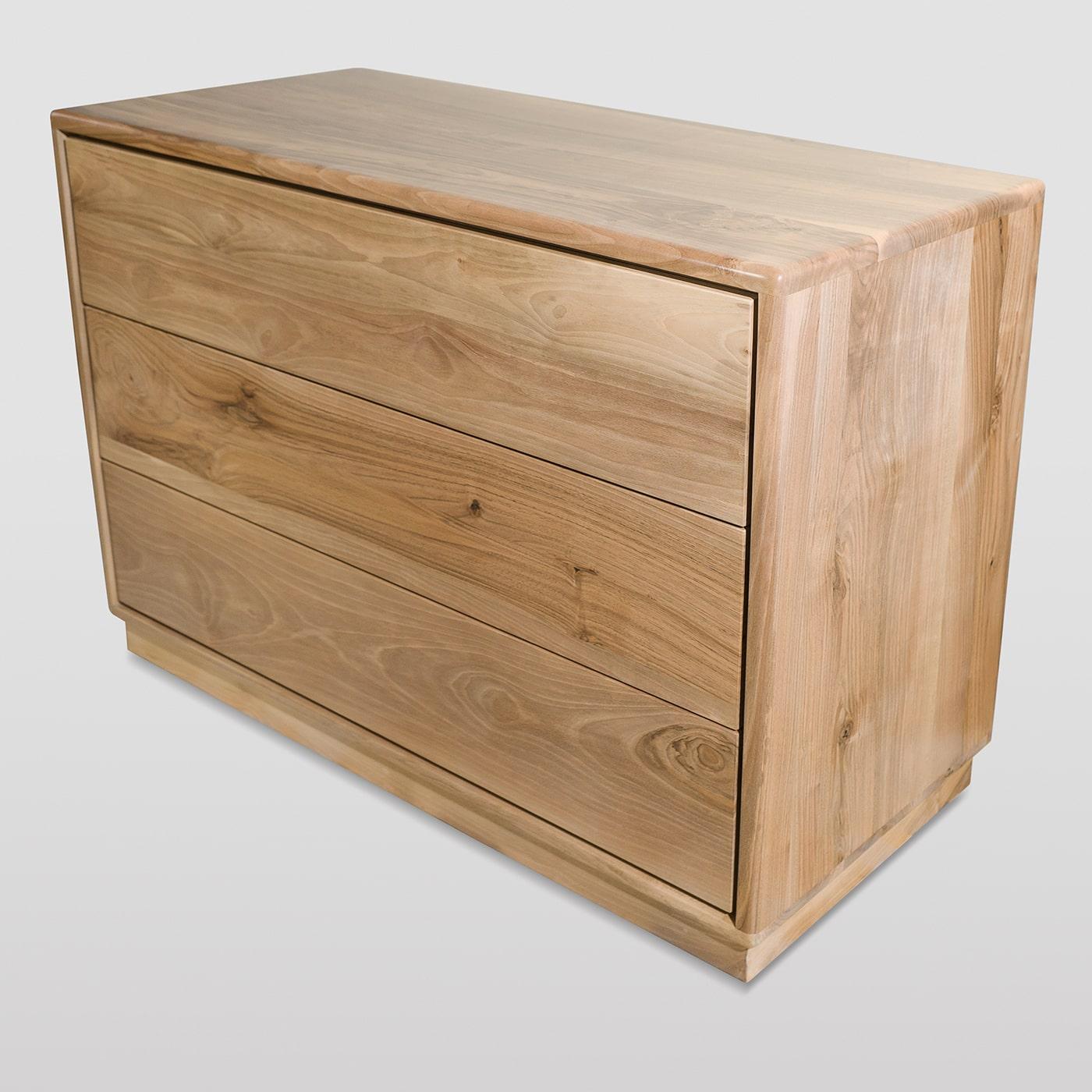 A superb expression of minimalist Nordic-inspired design, this dresser features three linear drawers and is handcrafted of solid Italian walnut. Internally fashioned of solid beechwood, the drawers are handle-free and feature a touch opening system