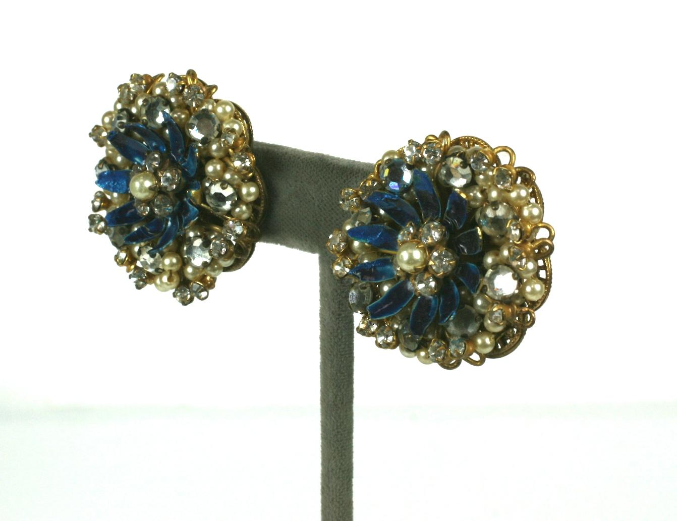 Haskell Style Flower Earrings with deep blue enamel centers. Crystal rose montees and faux pearls are sewn on gilt filigrees a la Haskell but these are more likely produced by Robert of New York.  1940's USA.
1.25