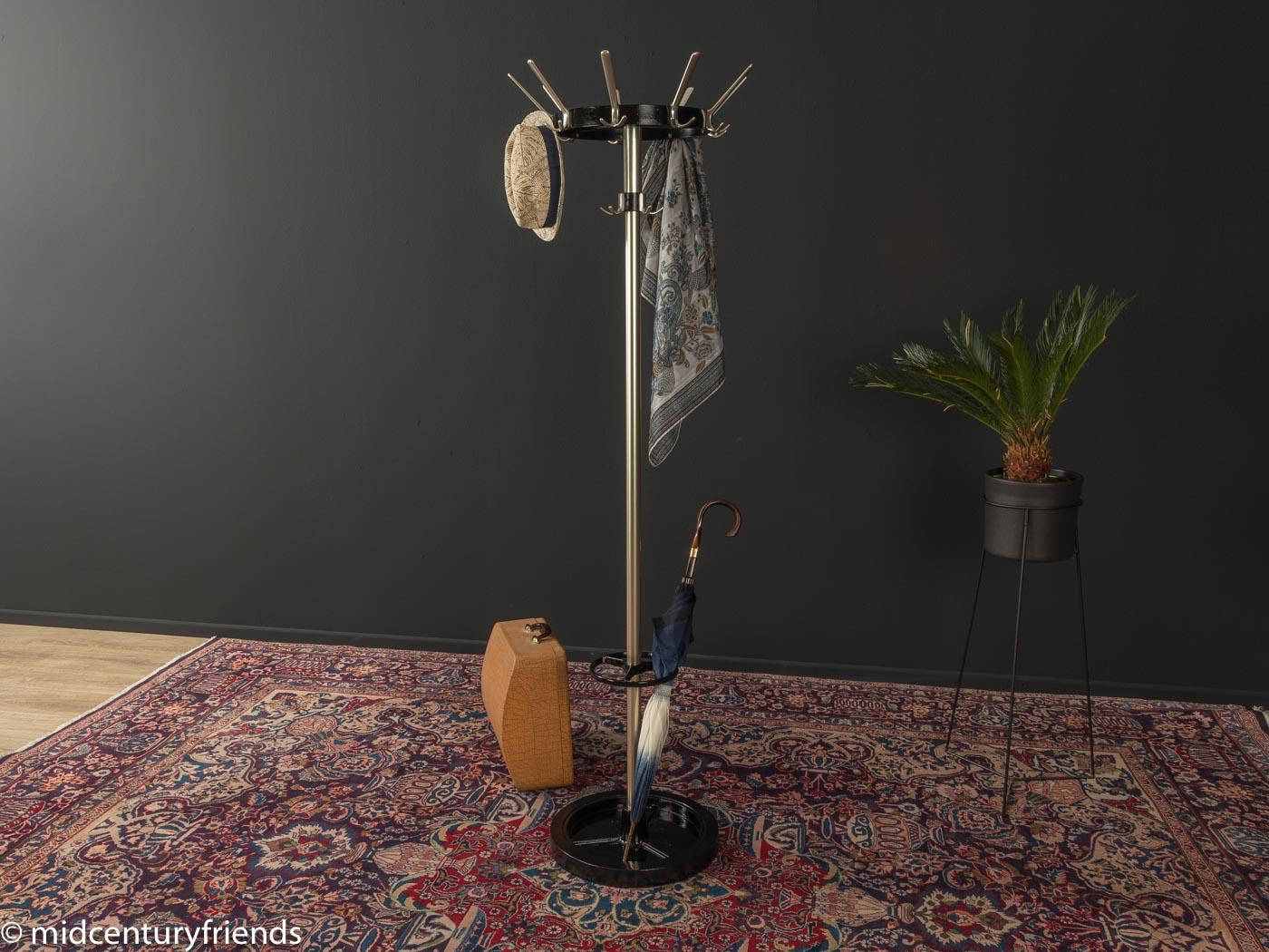 Classic hatstand from the 1960s. High quality, heavy stainless steel frame with nine hooks, an umbrella holder and a metal foot. The umbrella holder and the base are painted black. Made in Germany. 
