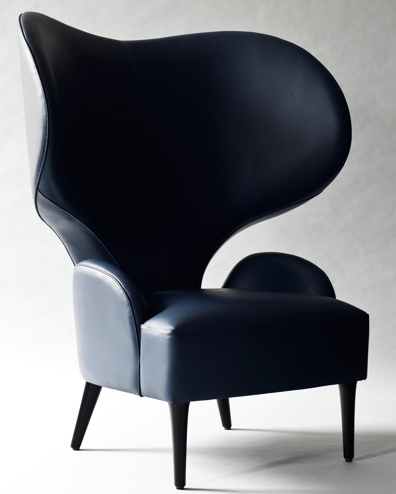 The Hathi side or lounge chair by DeMuro Das features an elegant winged back and generous proportions. The fully upholstered tight seat and back are supported by black lacquered wood legs.

Pricing is quoted COM - does not include fabric costs.