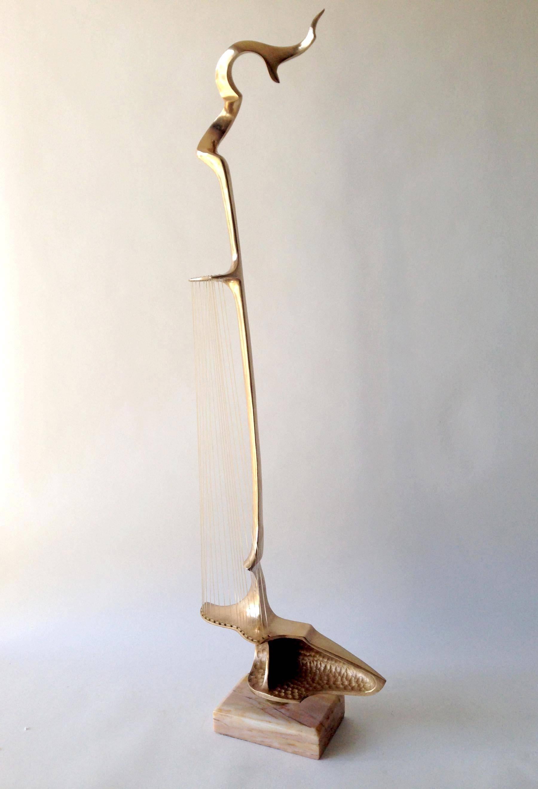 A modernist bronze lute sculpture created by Hattakitkosol Somchai of Thailand. Sculpture is comprised of a cast bronze lute with nylon strings and sits on a marble base. Piece is quite tall and measures 39