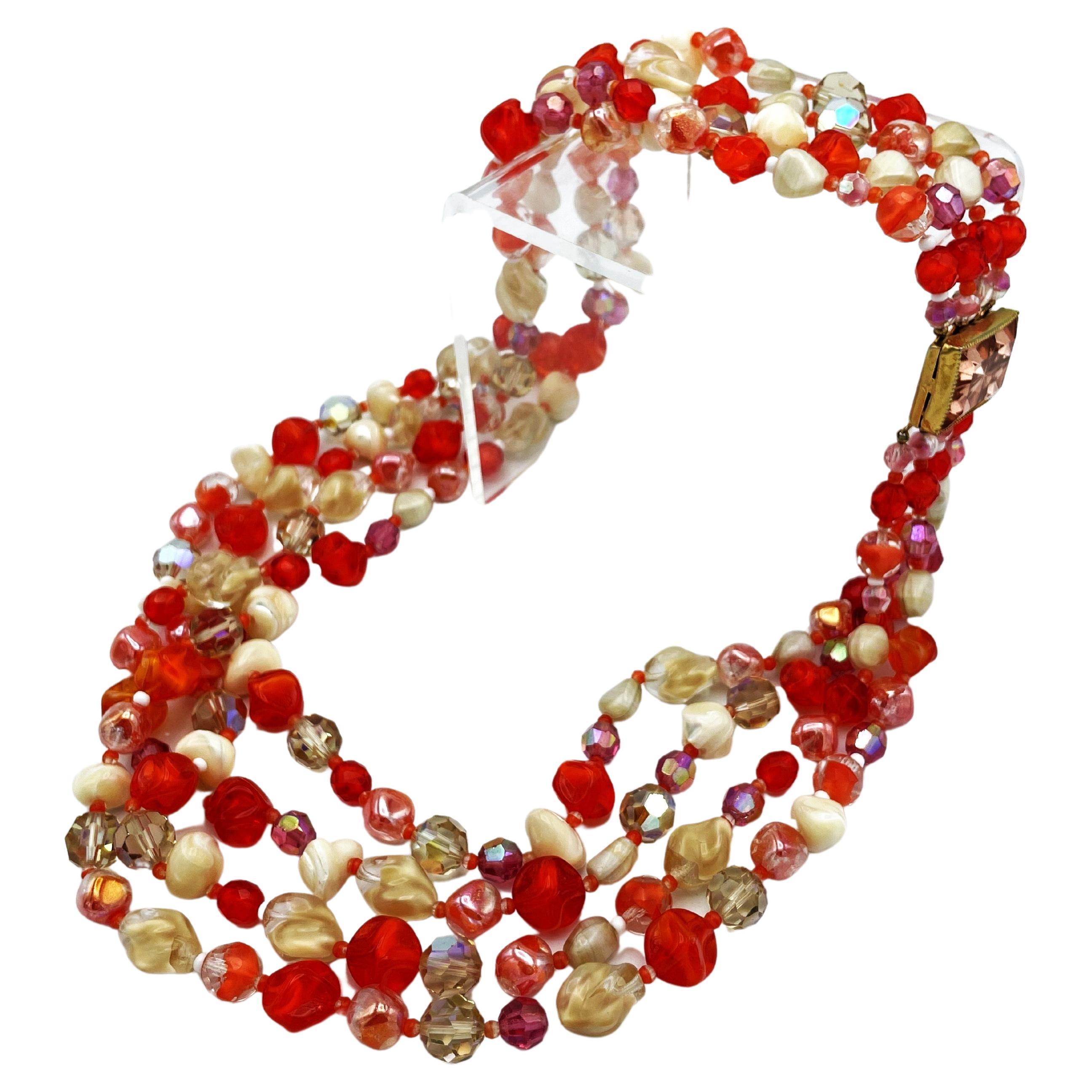 Very decorative 4 row chain with different glass beads in different beige and red  tones beads and ediffferent shapes.  Nice closure in pink.
Hattie Carnegie, born Henrietta Kanengeiser, was an Austrian-American jewelry and fashion designer of the