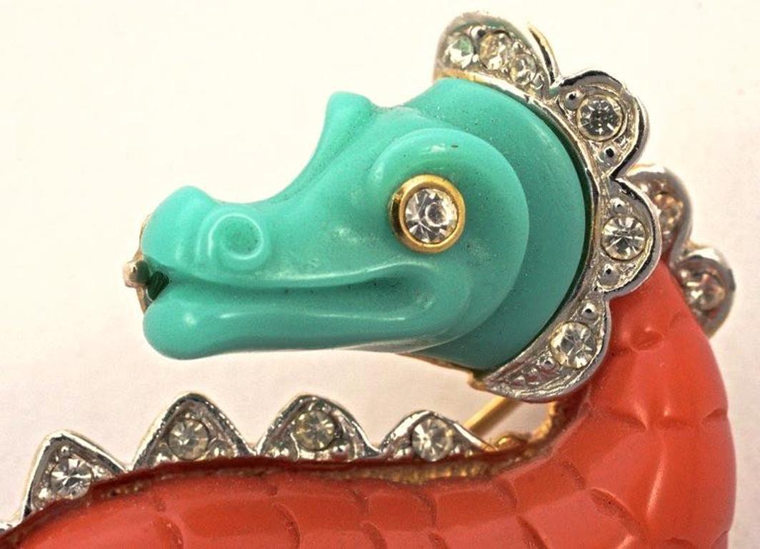 Unsigned Hattie Carnegie fantastic gold tone figural dragon brooch, embellished with clear faceted rhinestones, and featuring two moulded lucite sections in coral and turquoise. Measuring maximum width 3.7cm / 1.45 inches by length 4.5cm / 1.77