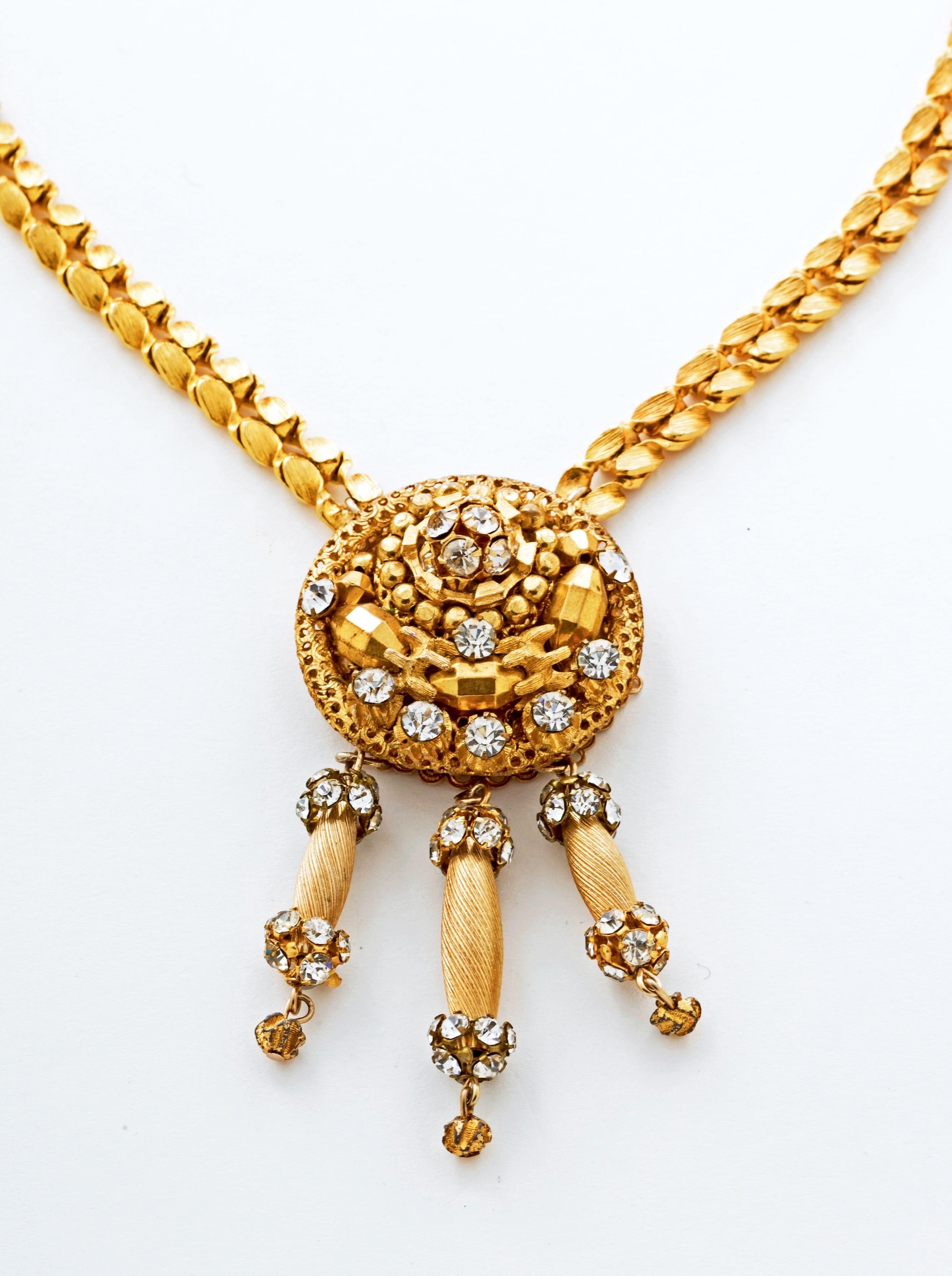 Stunning and Rare is this Vintage Hattie Carnegie Demi Parure.  Beautiful gold gilt metal and sparkling crystals make up this extraordinarily well designed necklace and matching earrings.  Both pieces are signed.  Note the earrings are clip but very