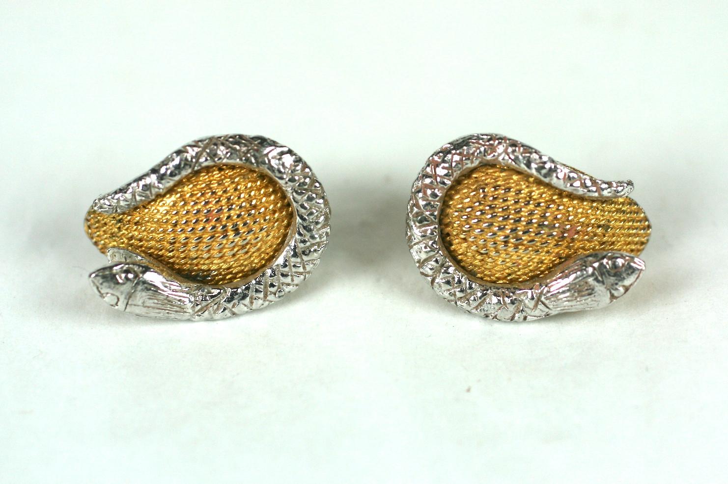 Hattie Carnegie Snake Earrings with clip back fittings. Silver toned snakes wind up the side of textured gilt petals. 
1950's USA.   1.25