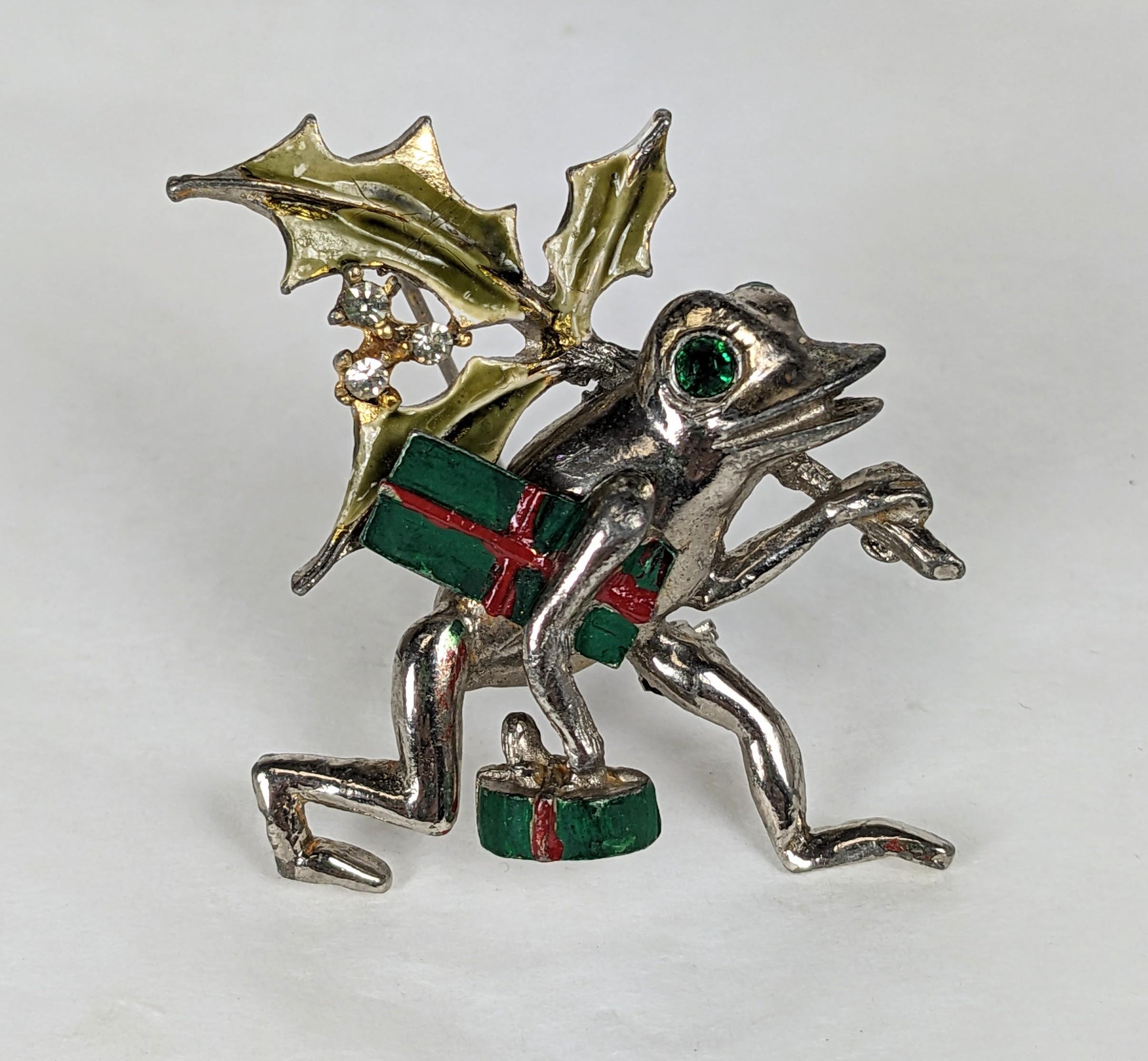 Charming Hattie Carnegie's Holiday Festive Frog from the 1950's. He's carrying presents and mistletoe to his next party.
Silvertone enamel with hand enameling. 1950's USA. 1.5