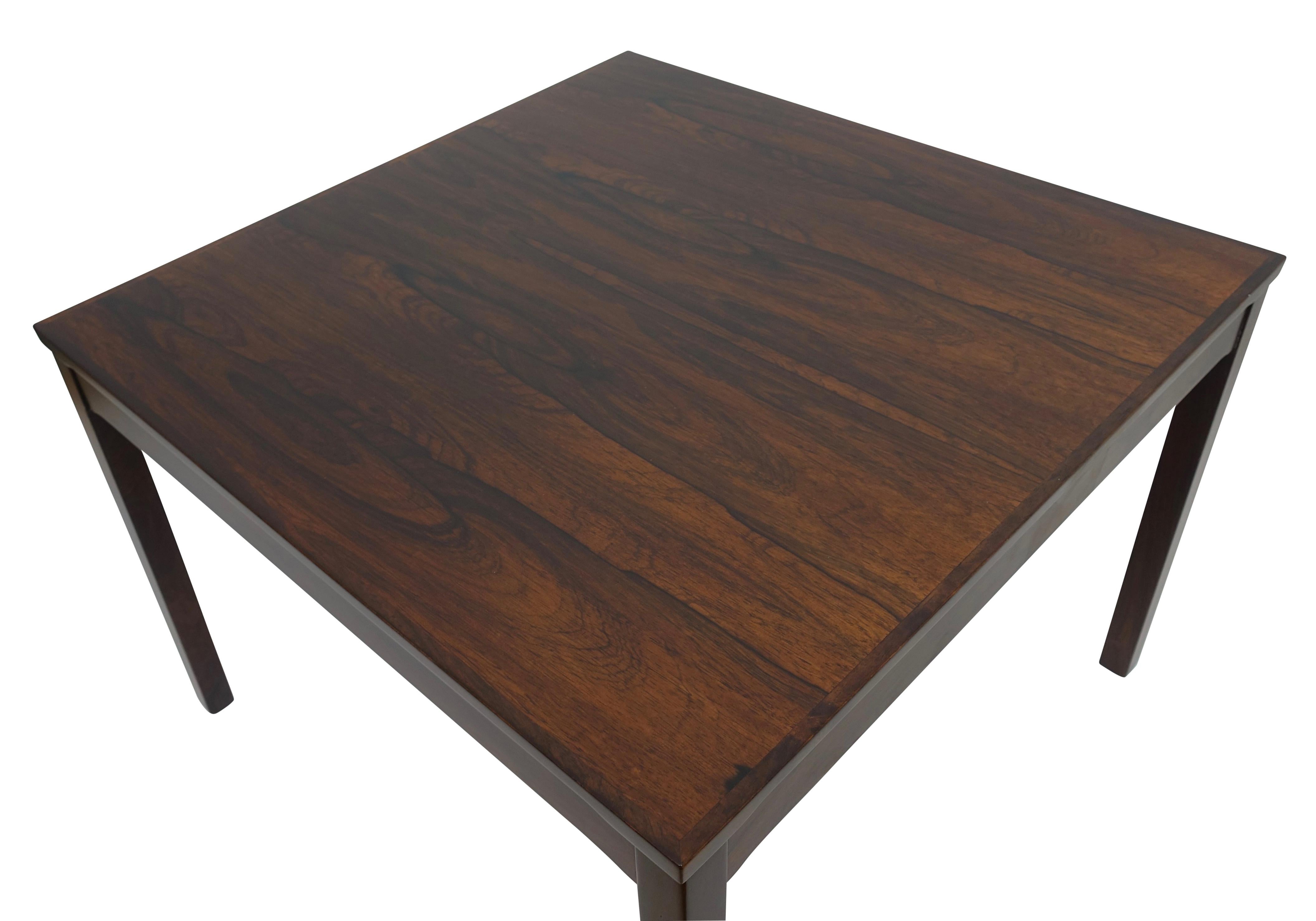 bookmatched rosewood square shape coffee table, having square rosewood legs. Simplicity at its most intriguing. Original Haug Snekkeri label on the underside, as seen in the photo's. Norway, mid to late 20th century.