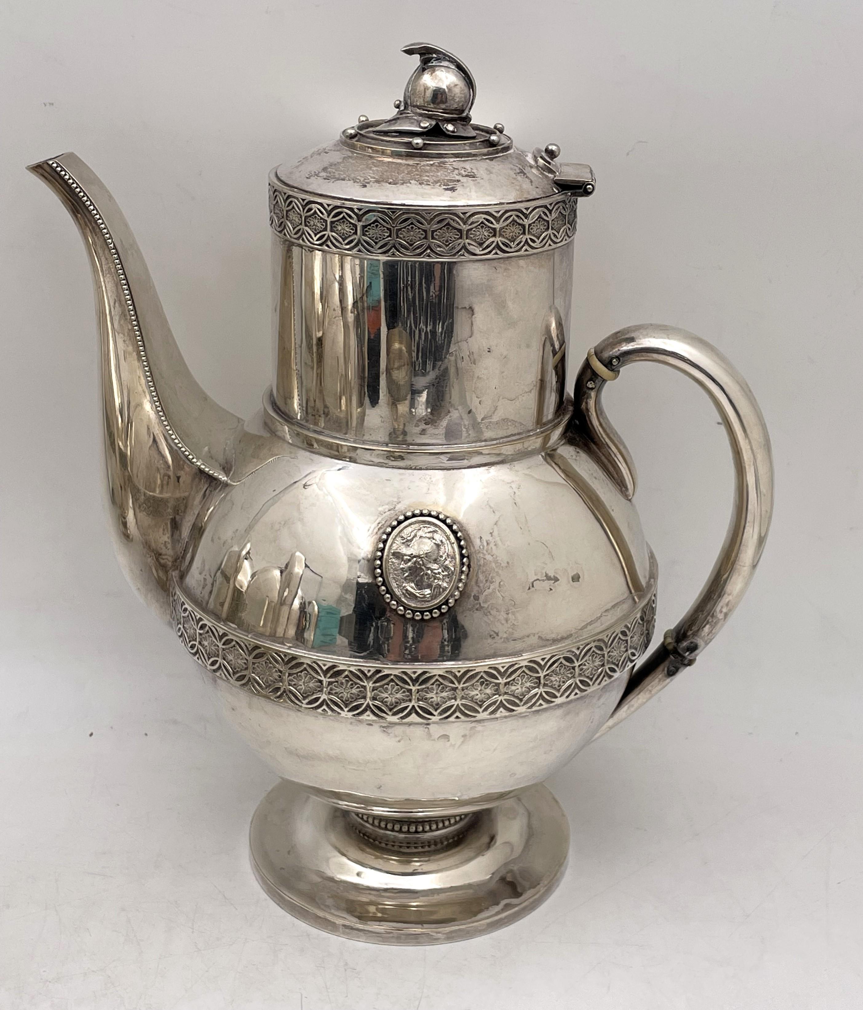 E. V. Haughwout & Co. silver soldered, mid-19th century 5-piece tea and coffee set in the Helmet Medallion pattern, consisting of:

- a coffee pot measuring 11 1/2