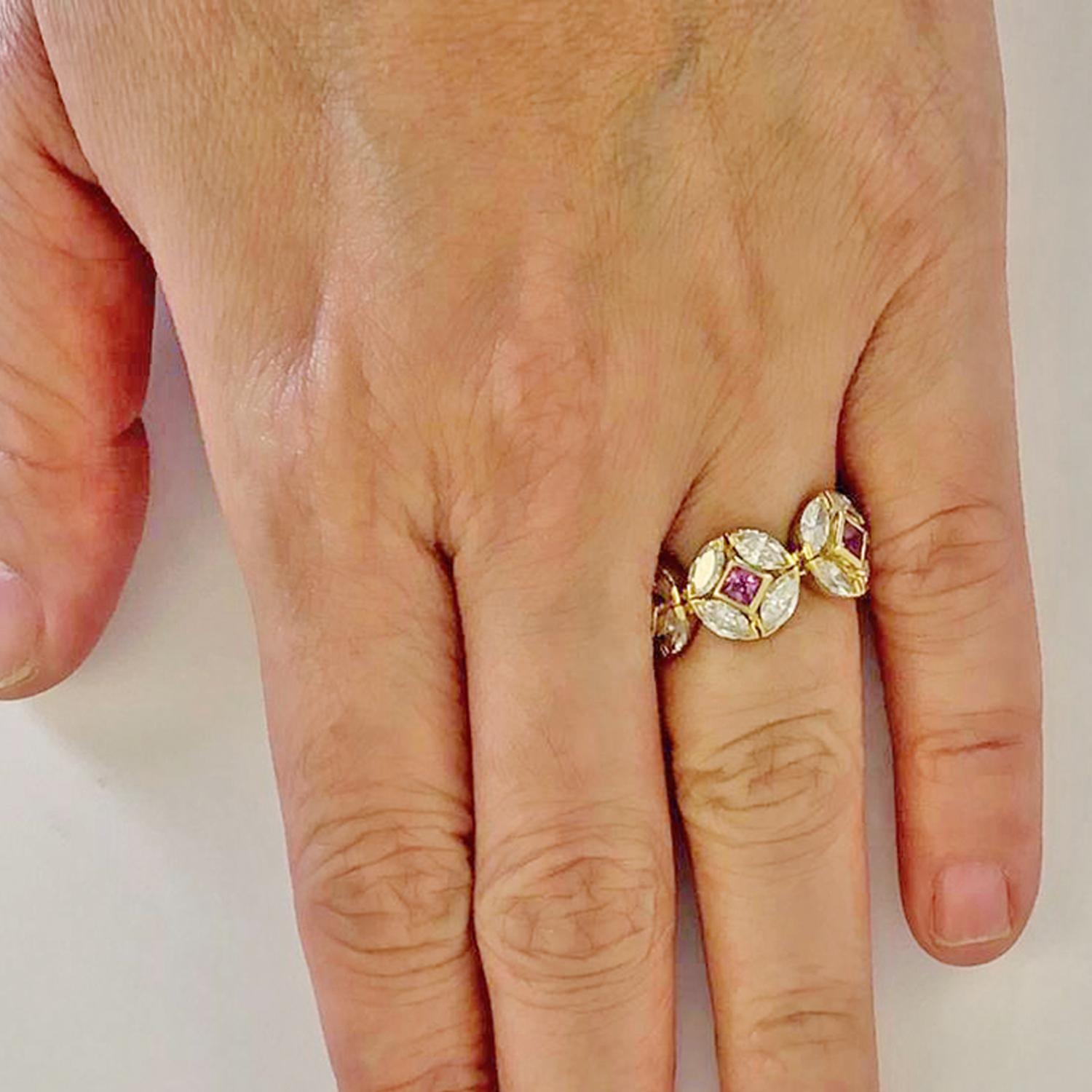 HAUME Diamond Pink Sapphire Eternity Band Ring in 18k Yellow Gold.
A unique eternity band by Adria de Haume, with round florets repeated throughout. Each motif is comprised of four marquise-shaped diamond petals with a princess-cut pink sapphire