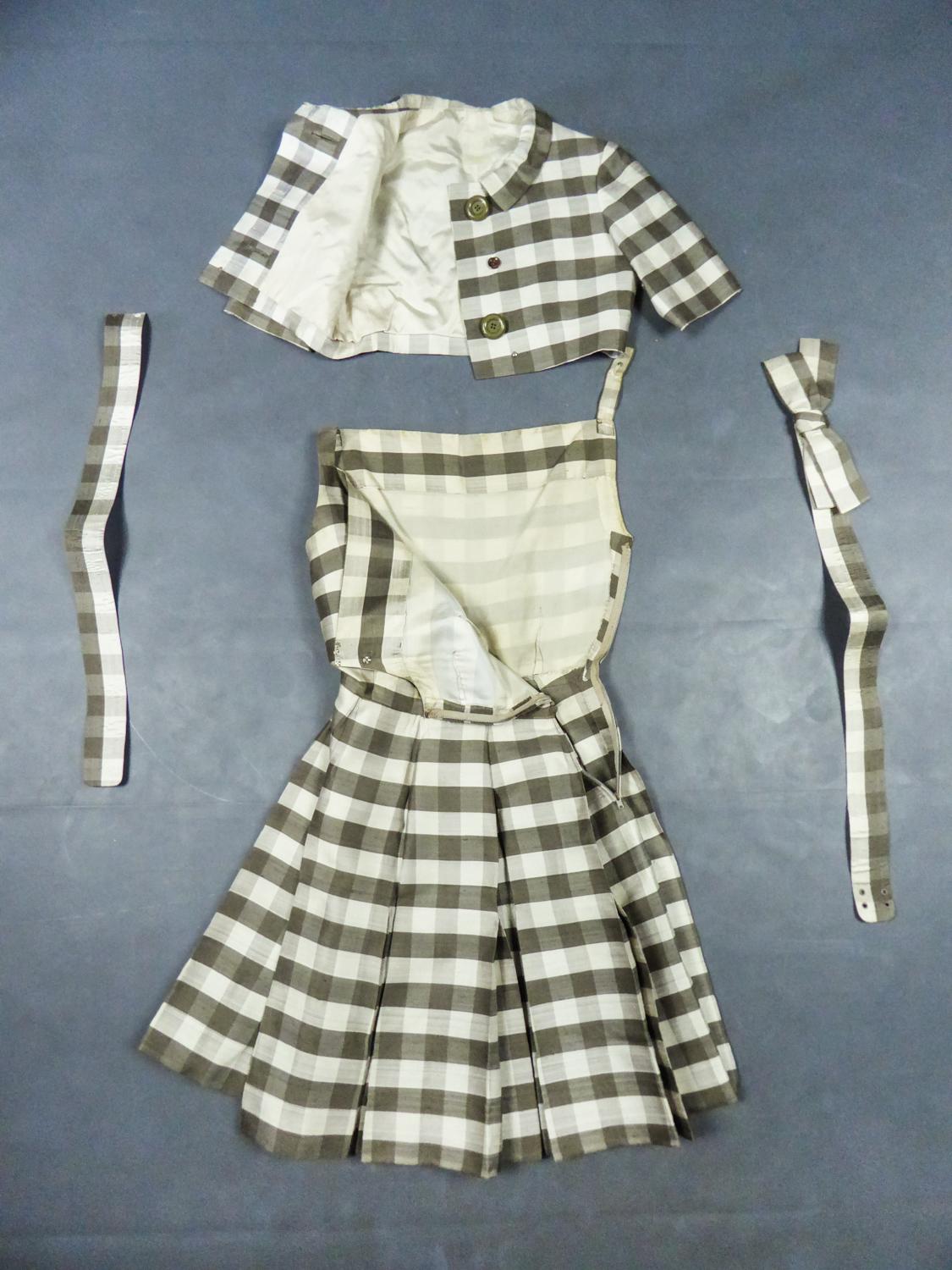 Circa 1959/1962
France Paris

Haute Couture Nina Ricci Dress, Bolero and two belts set dating from the early 1960s. Beautiful wild silk woven with large brown and cream checks. Sleeveless dress flaring from the waist and skirt with double flat box