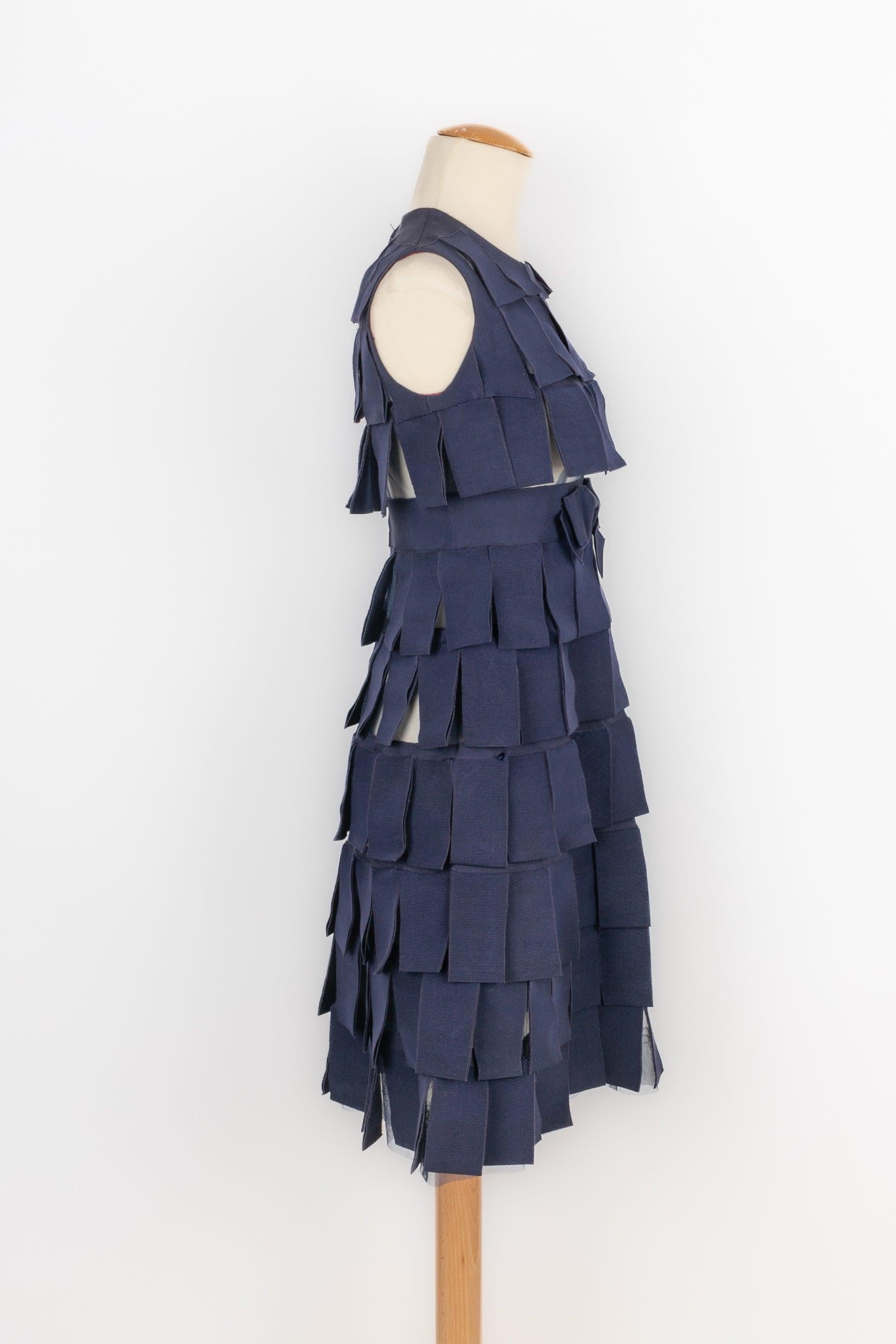 Vintage dress made of navy-blue tulle ribbons layering. The waist is enhanced with a mounted belt decorated with a bow. No size indicated, it fits a 36FR.

Additional information:
Condition: Very good condition
Dimensions: Chest: 40 cm - Waist: 33