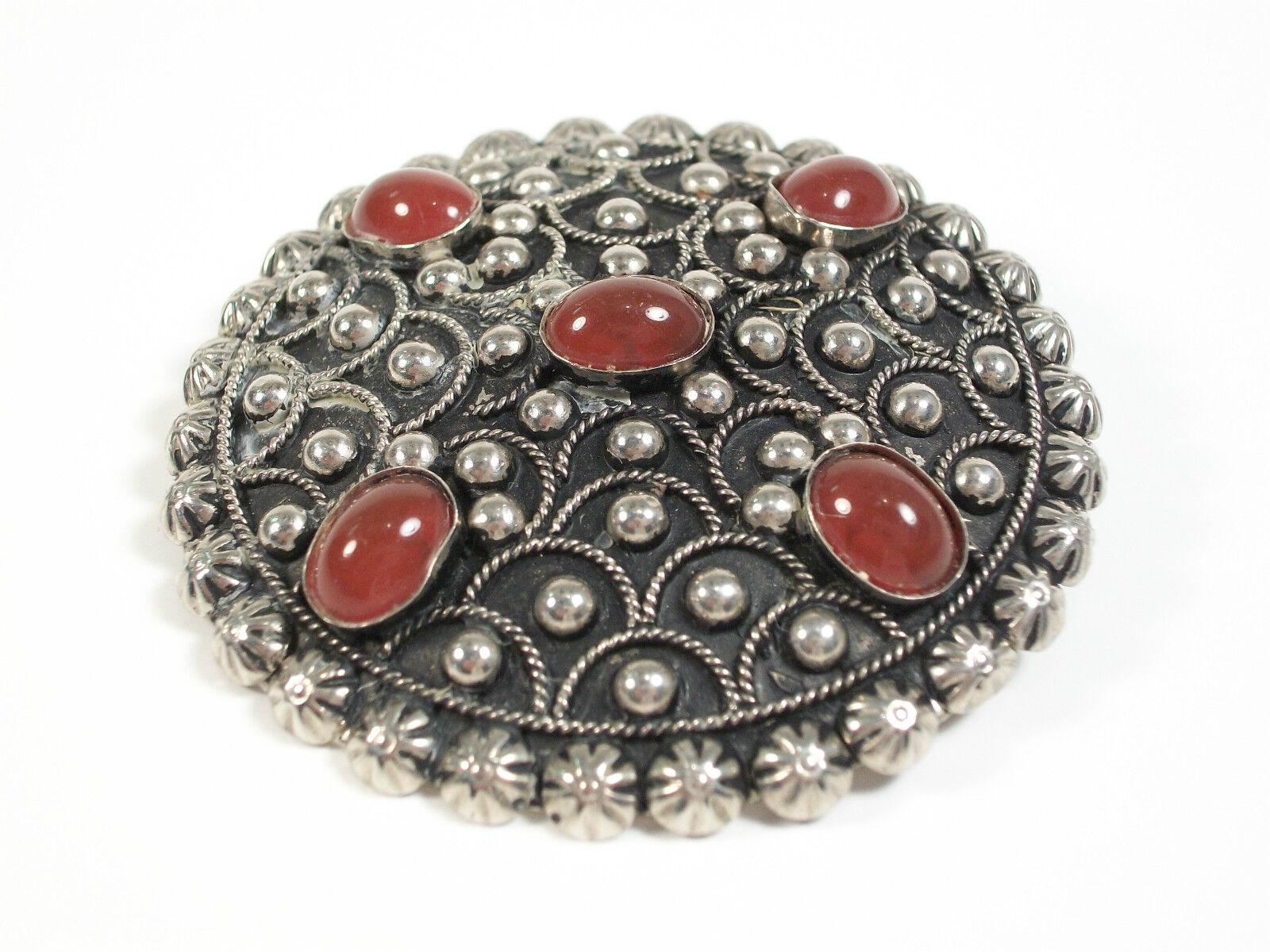 Vintage silver tone brooch or pendant (can be worn either way) - with five bezel set cabochon faux carnelian (glass) stones - Italy - circa 1960's.

Excellent vintage condition - no loss - no damage - no repairs - tarnishing and surface scratches