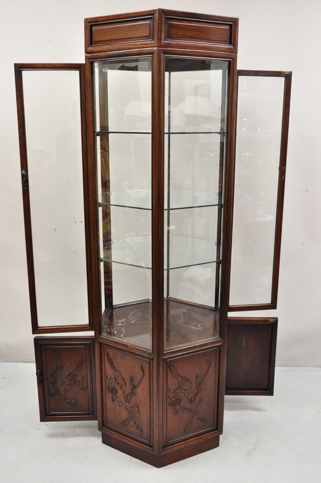 Vintage Oriental Chinoiserie Asian Mahogany Hexagonal Lighted Display Curio Cabinet. Item features double sided entry and lower cabinets, bird carved details, 3 adjustable glass shelves, lighted interior, beautiful wood grain, very nice vintage