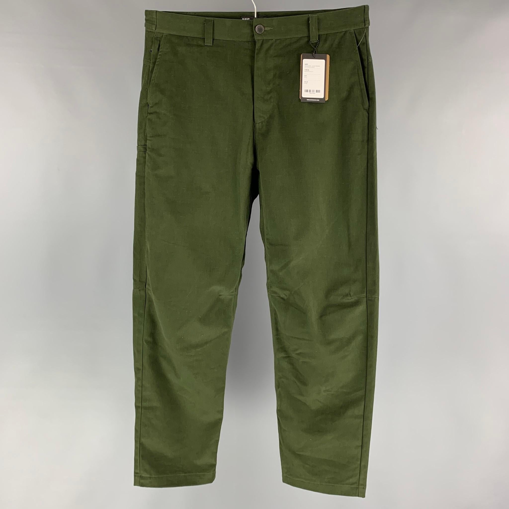 HAVEN 'Opus Pants' casual pants comes in a green cotton twill fabric featuring a slate style, a zip up pocket, a lateral pocket, snap button detail at waistband and a button fly closure. Made in Canada.

New With Tags.
Marked: