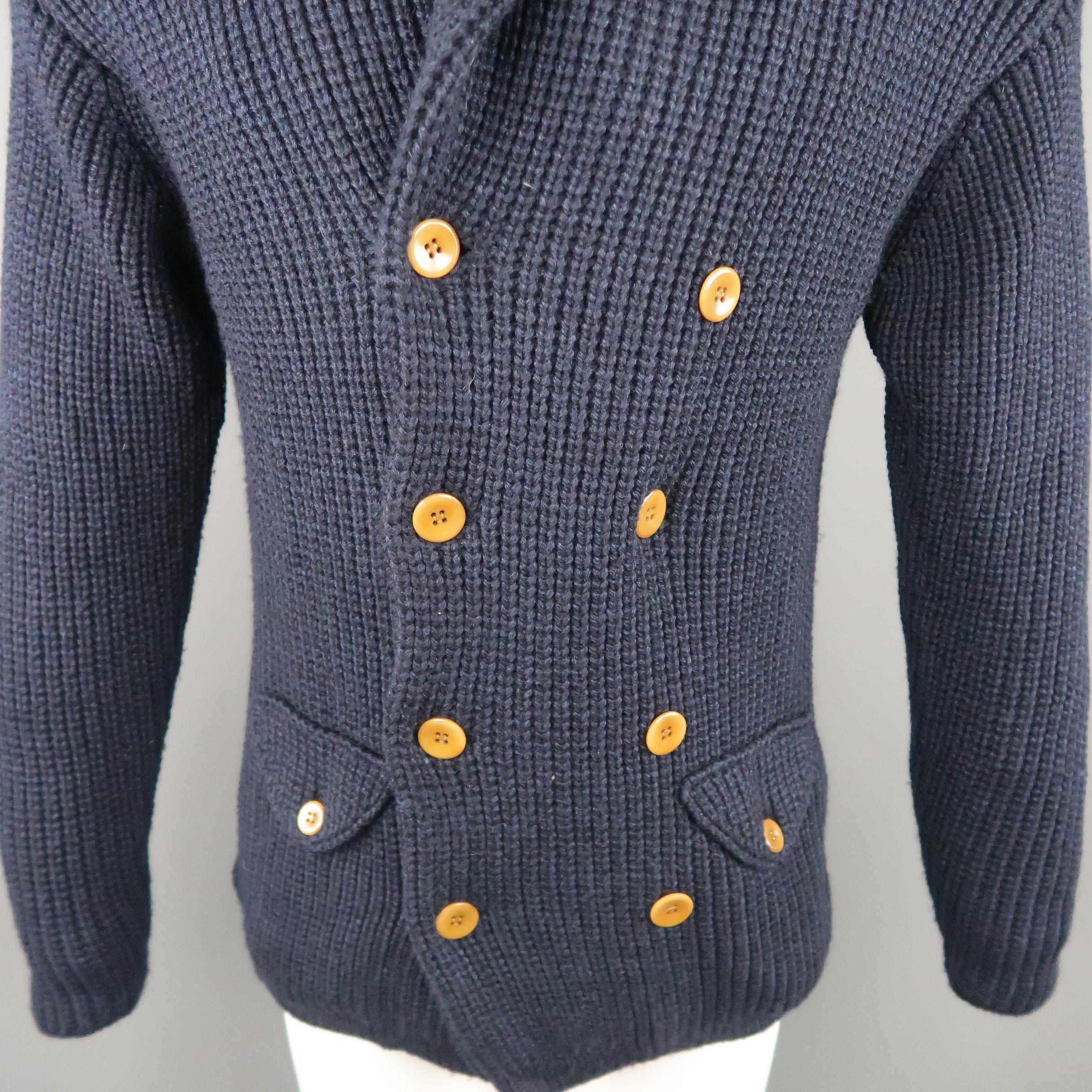 HAVER SACK cardigan comes in a heavy wool blend knit with a shawl collar, double breasted button up front, and flap pockets at waist. Made in Japan.
 
Excellent Pre-Owned Condition.
Marked: M
 
Measurements:
 
Shoulder: 21 in.
Chest: 42 in.
Sleeve: