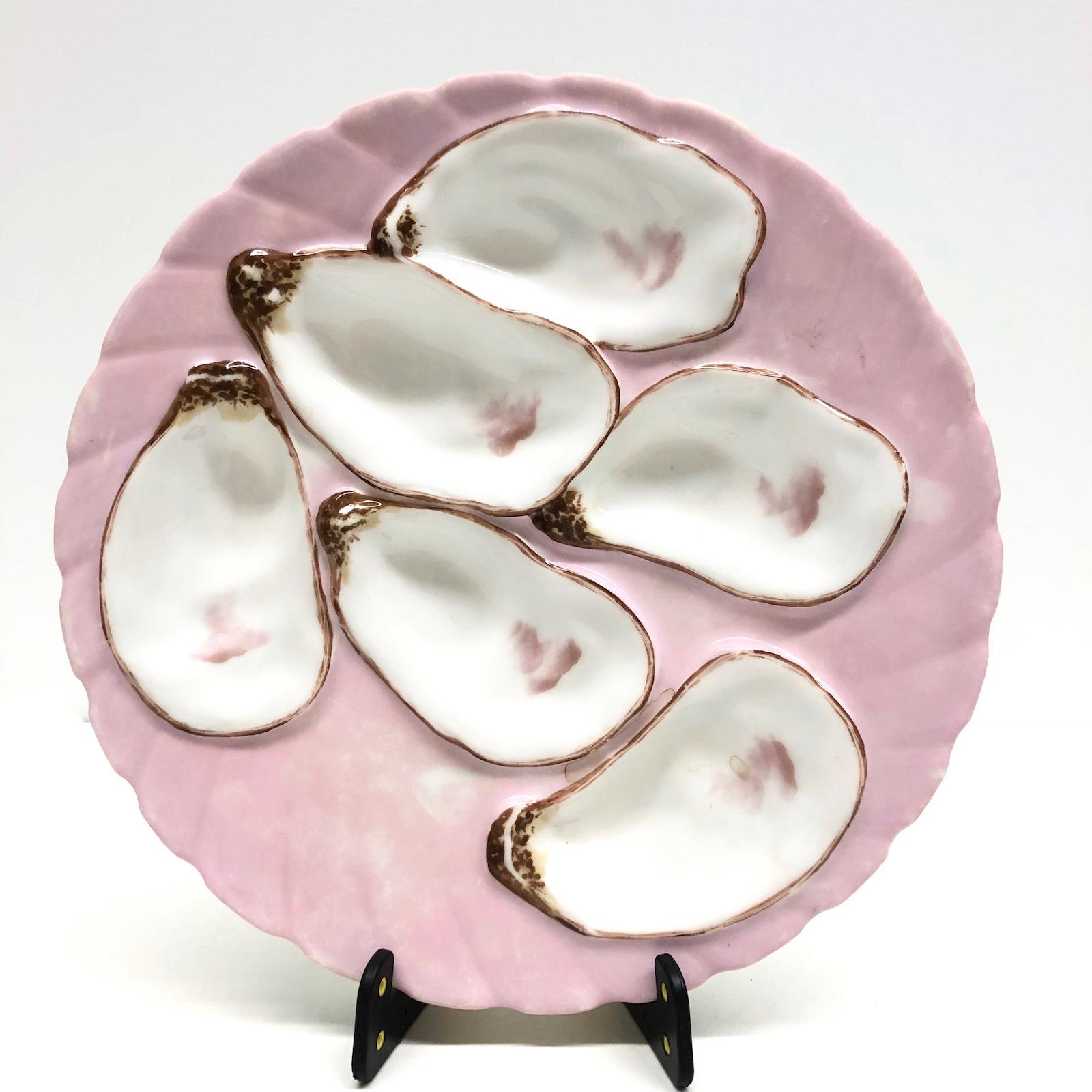 This beautiful oyster plate features 6 wells for oysters. It is marked at the back. Nice addition to your table or just to display.
 