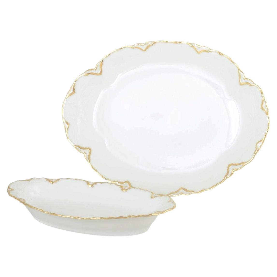 Haviland, France. Pair of oval porcelain dishes in cream tone with gilded edges.