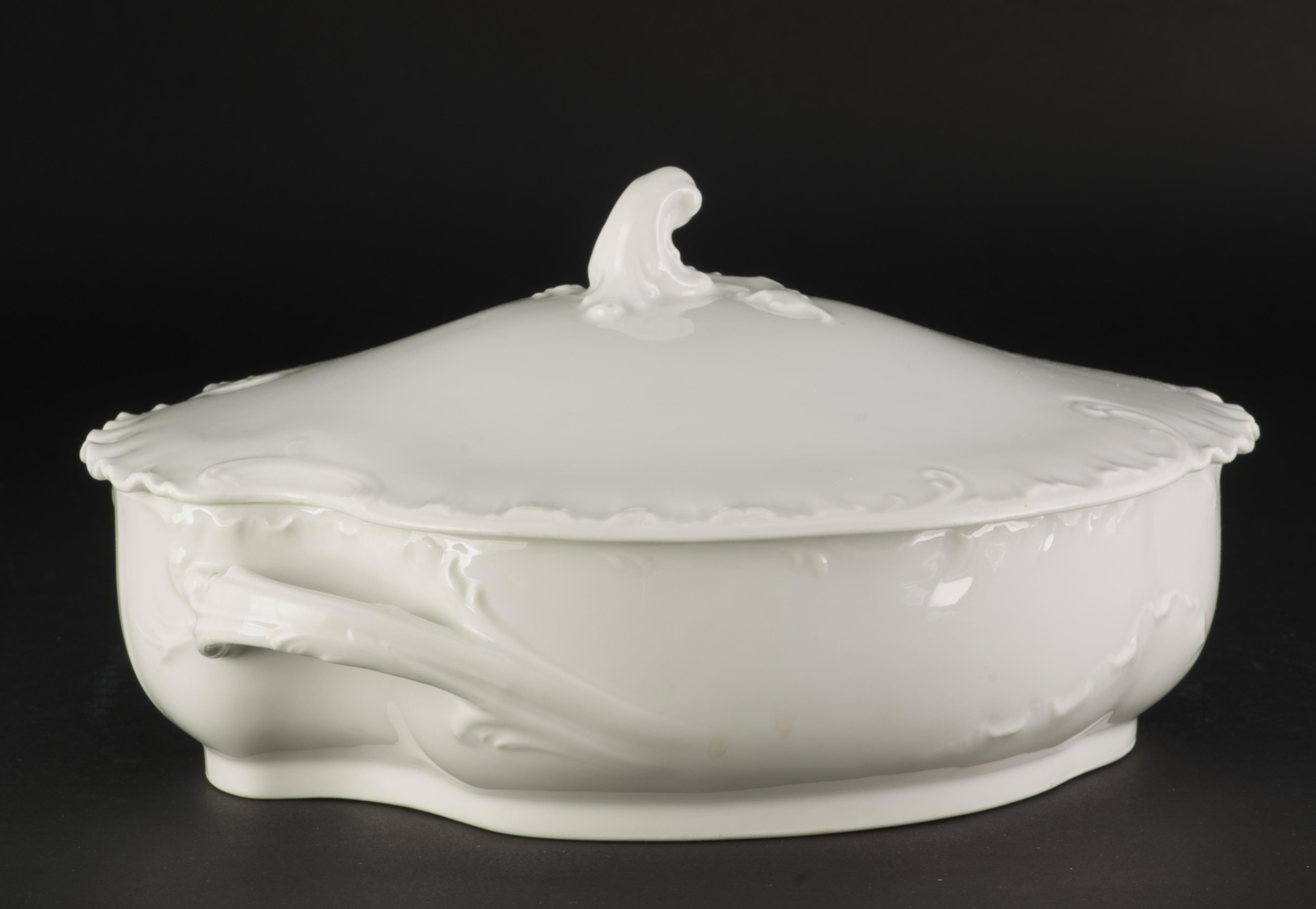 Haviland Limoges Oval Bowl with Cover is in Marseille (or Schleiger 9) shape; it is all white in color. The bowl has complicated asymmetrical shape with elaborate textured decor on both bowl and cover and scalloped double rim on the cover. The bowl