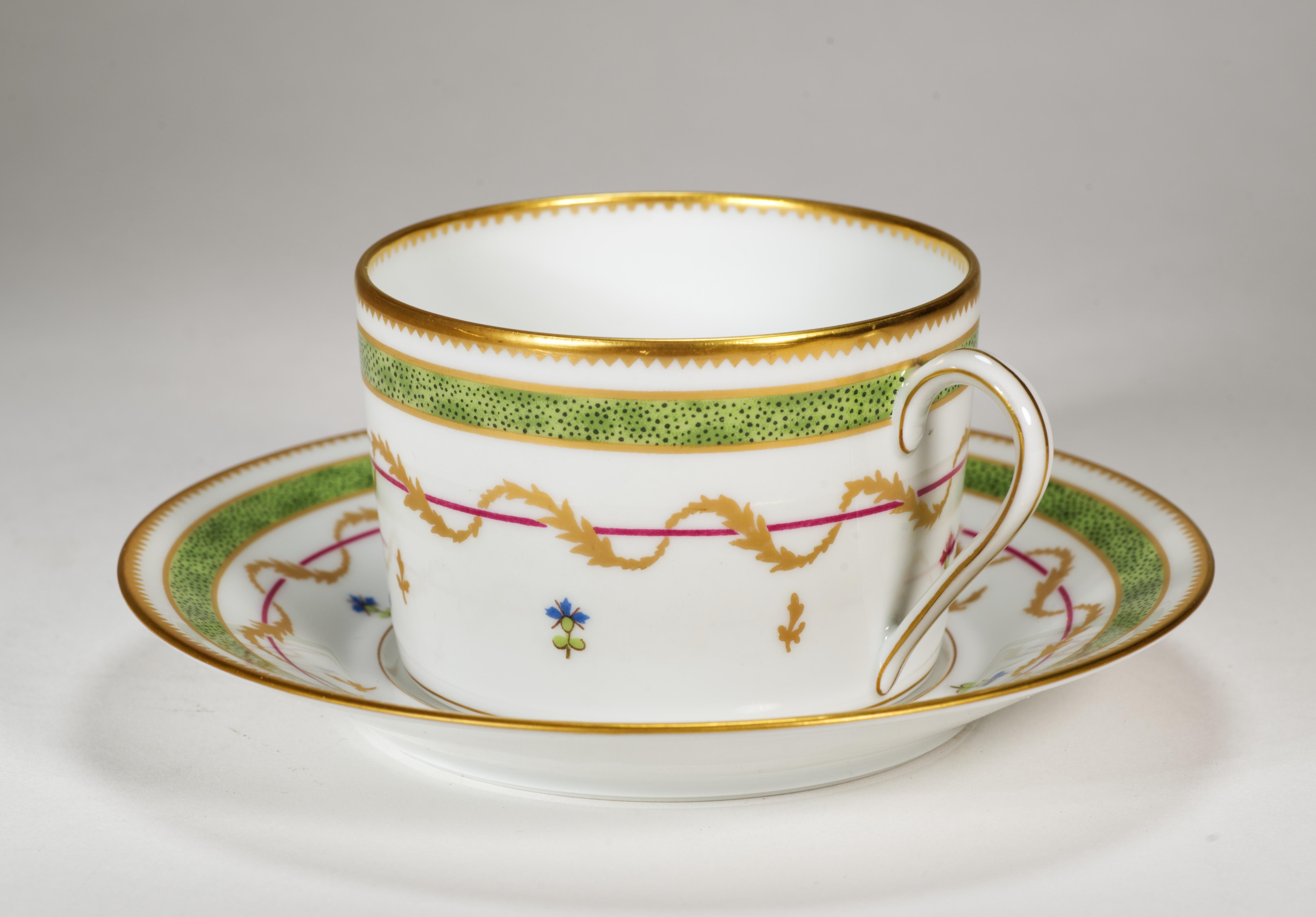  Vintage set of cup and saucer features Vieux Paris decor in green colorway on thin, semi-translucent porcelain. The pattern consists of cornflowers in blue, purple and gold colors, accentuating the gold laurel wreath medallion, and the green on