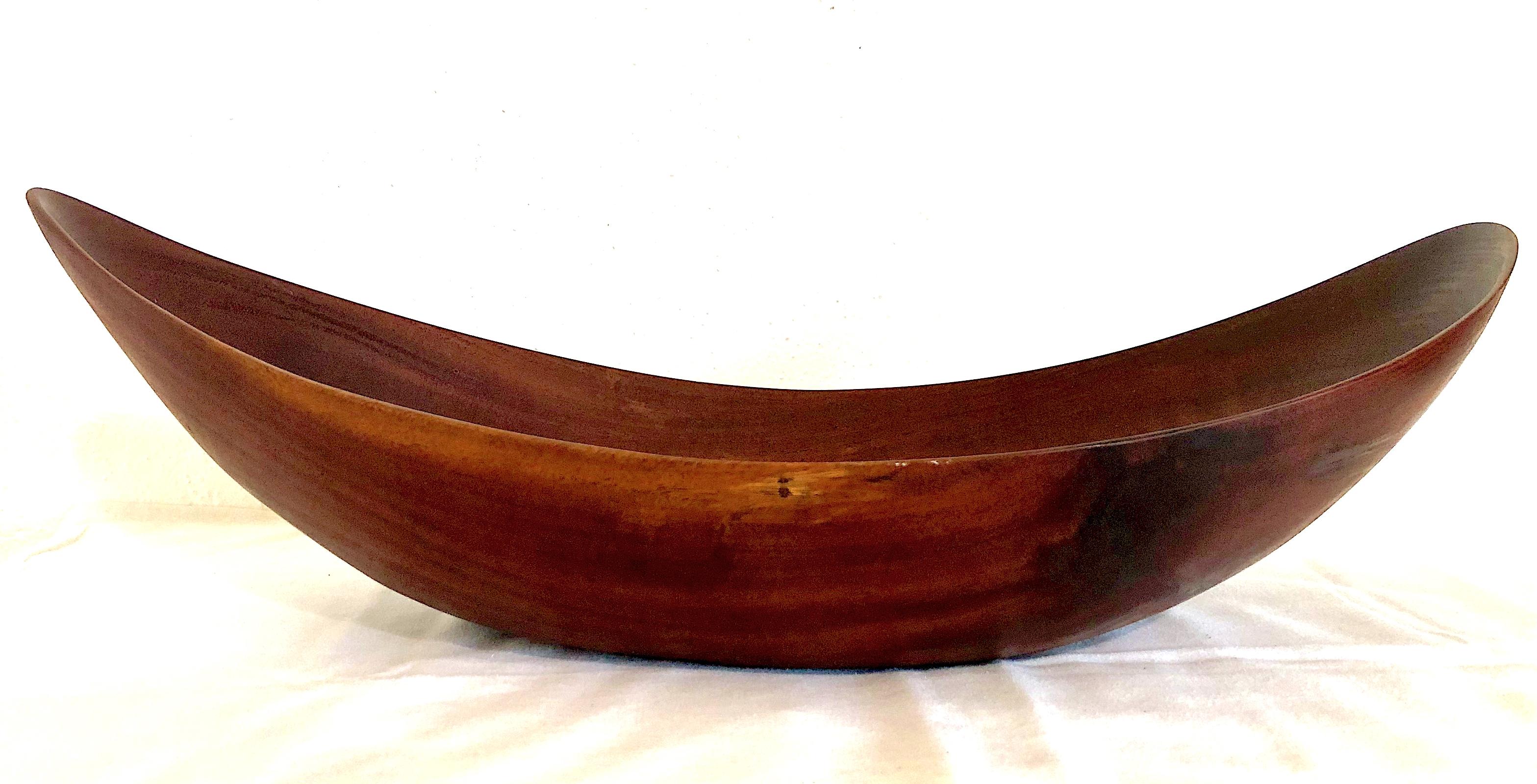 The purity of shape and the glory in the material make this sleek 18-inch wooden bowl a sculptural masterwork that would grace any contemporary-style interior. 
 
