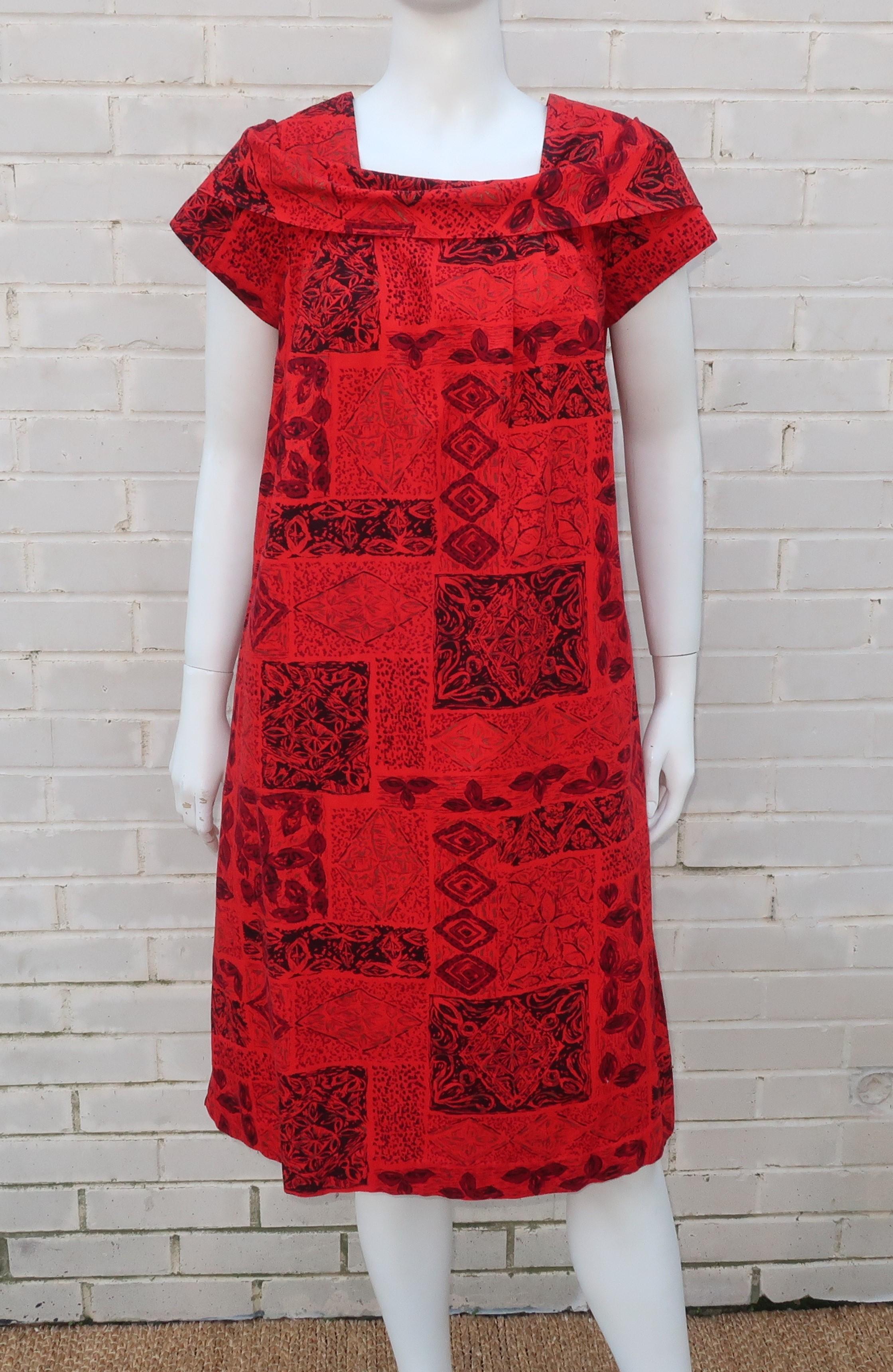 Aloha!  This classic Hawaiian muumuu dress is from the Lei-O-Hawaii label and features an exotically printed fabric in shades of red and black with a touch of gold for good measure.  As with all classic muumuus, the dress is fitted at the shoulders