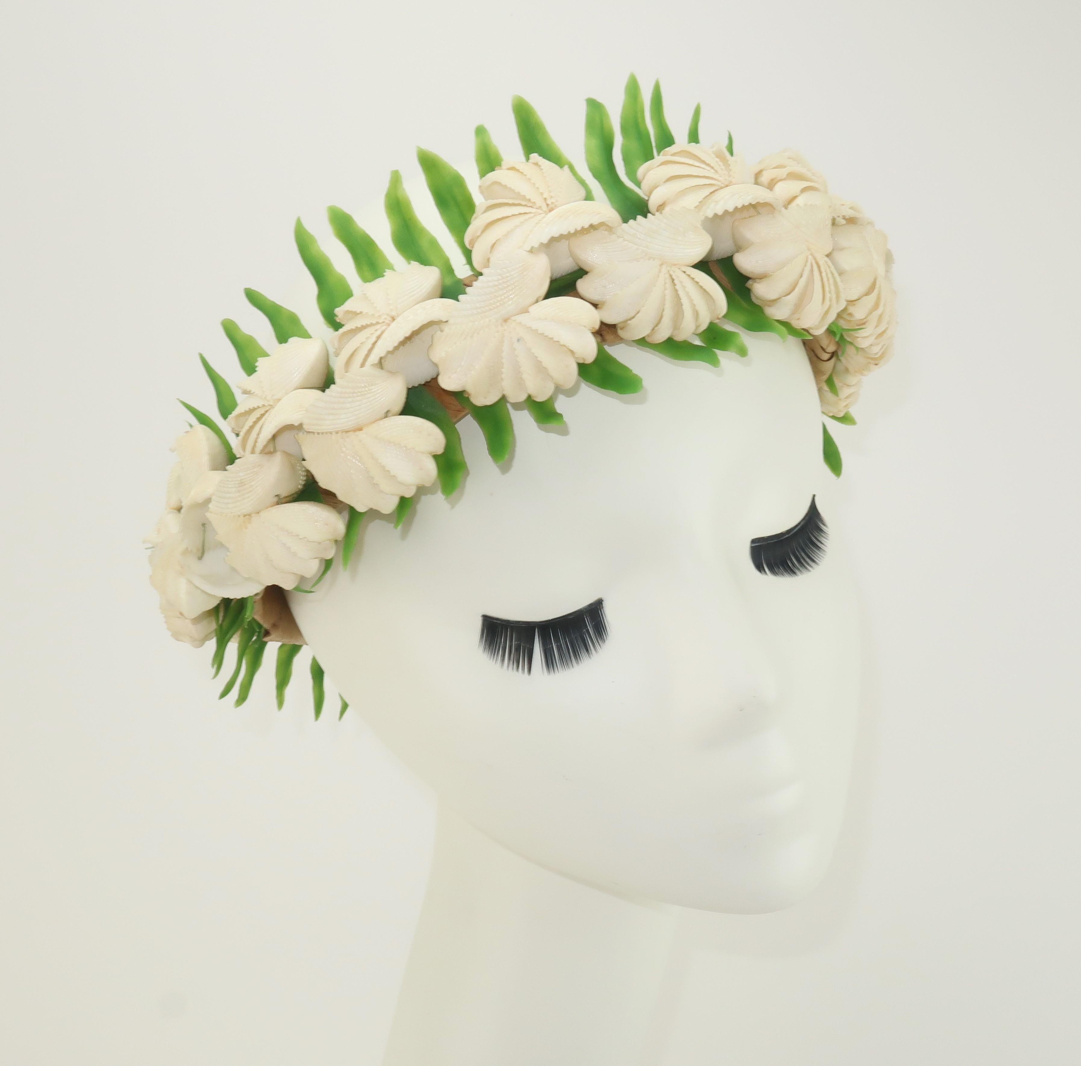 A crown fit for a mermaid!  The 1960's Hawaiian wedding crown constructed from a straw headband intricately embellished by braids of sea shells and faux ferns is a beautiful symbol of love and peace.  Perfect for a bride though equally as wonderful