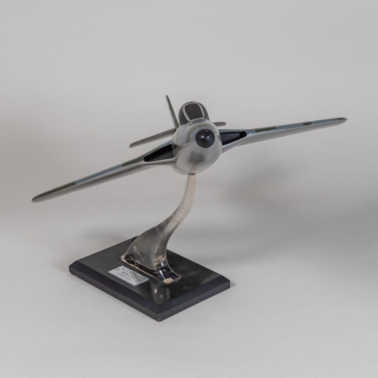 A painted carved wooden model of a Hawker Hunter in RAF livery with an interesting provenance, circa 1955. The model is mounted on a wood and acrylic stand with engraved plaque and is in original, unrestored condition.
The plaque is engraved:
W.J.