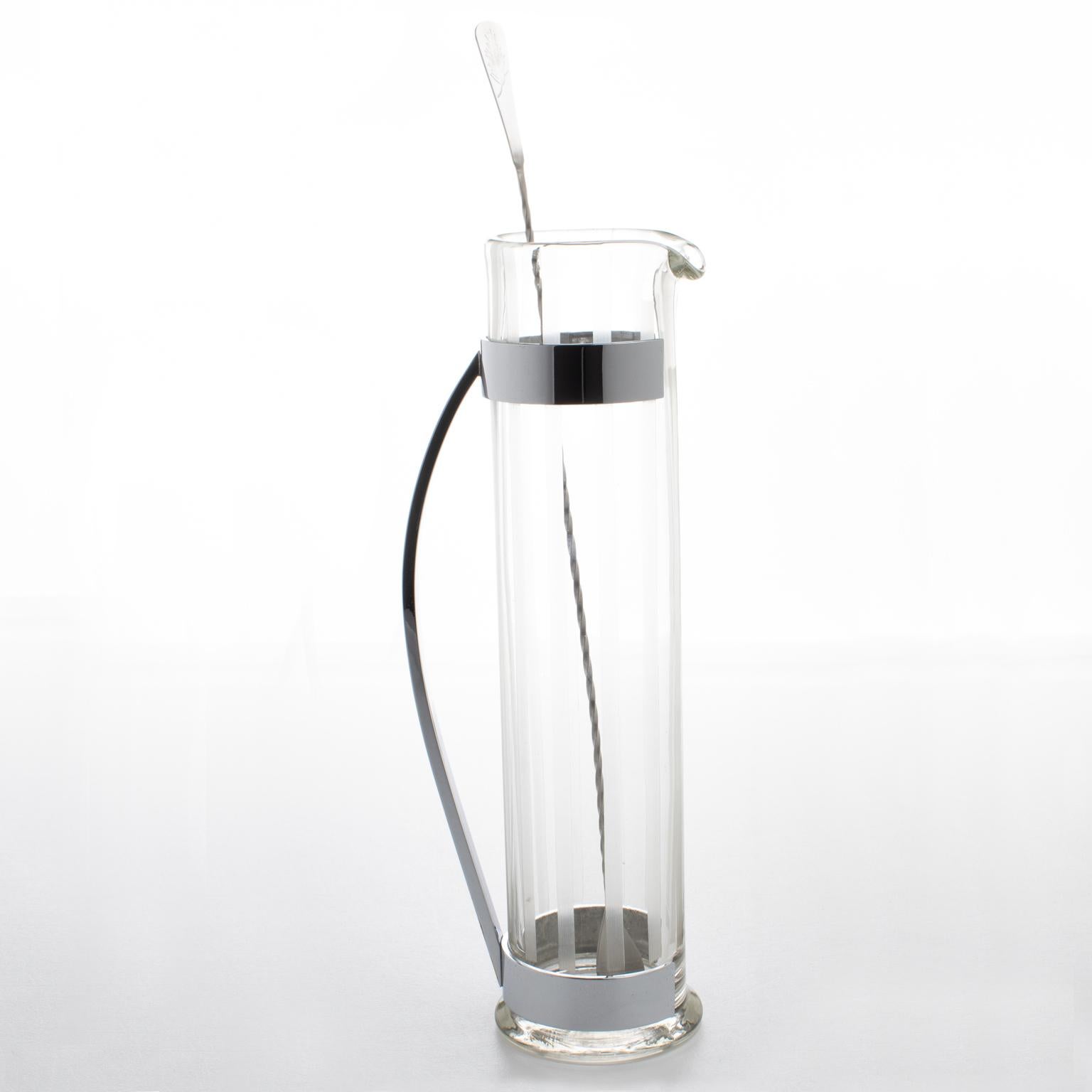 Hawkes Inc. designed this superb streamlined American Art Deco barware pitcher in the 1940s. The sleek modernist super extra-tall design features a hand-blown Martini pitcher or mixer jug and a long stirrer spoon. The glass body of the pitcher has a