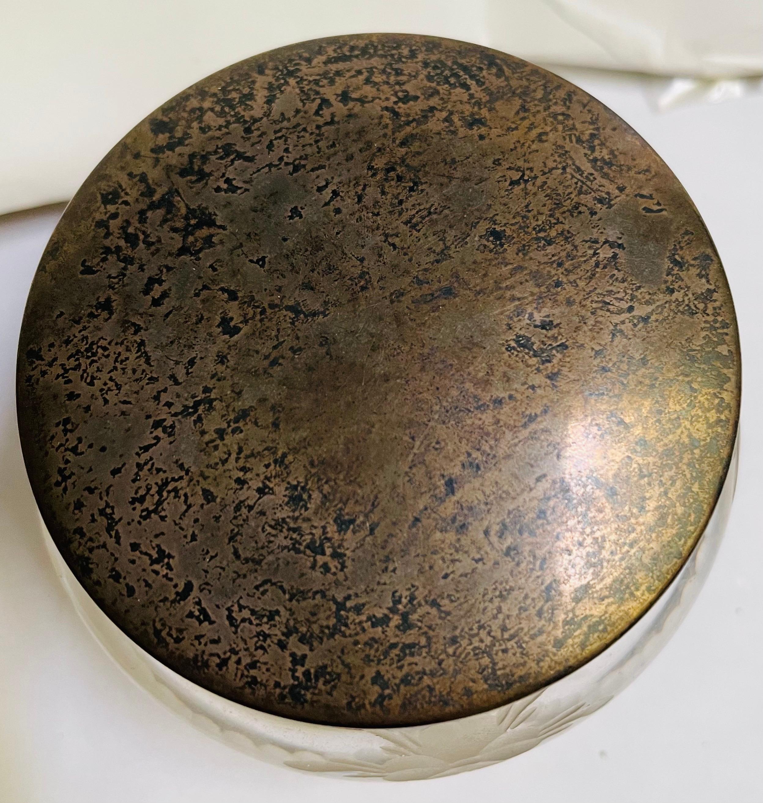 This is a lovely cut glass powder jar with a pretty repeating floral and swag design cut around the jar. It has a plain and simple sterling silver top that is signed Hawkes Sterling with an identifying number.  There is a small dent on the top that